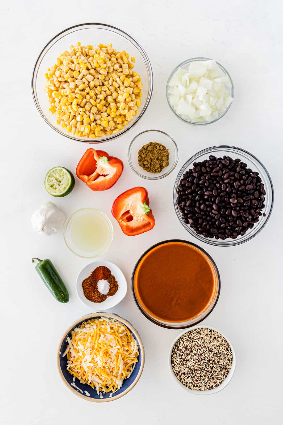 the ingredients for the quinoa casserole lined up on a white board