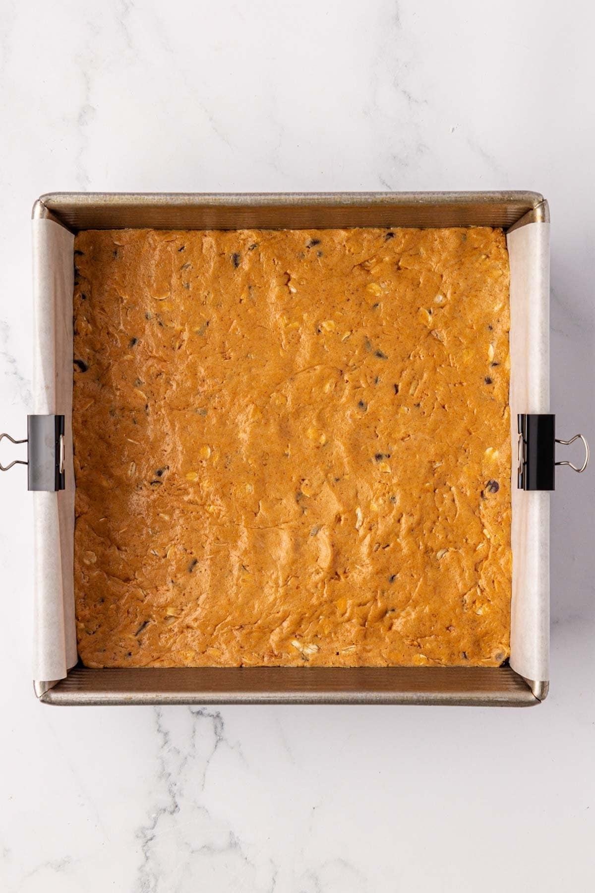 protein bar batter in a lined baking dish