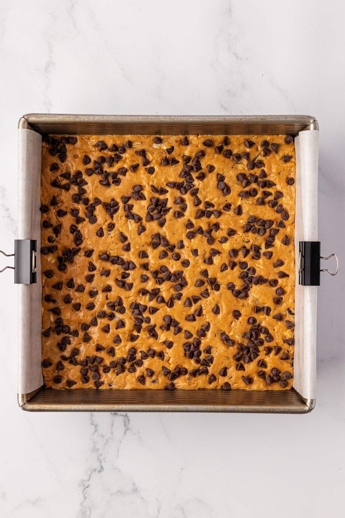 protein bar batter topped with mini chocolate chips
