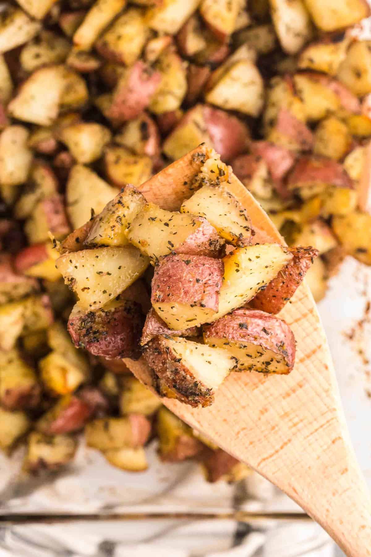 scooping red potatoes from the pan