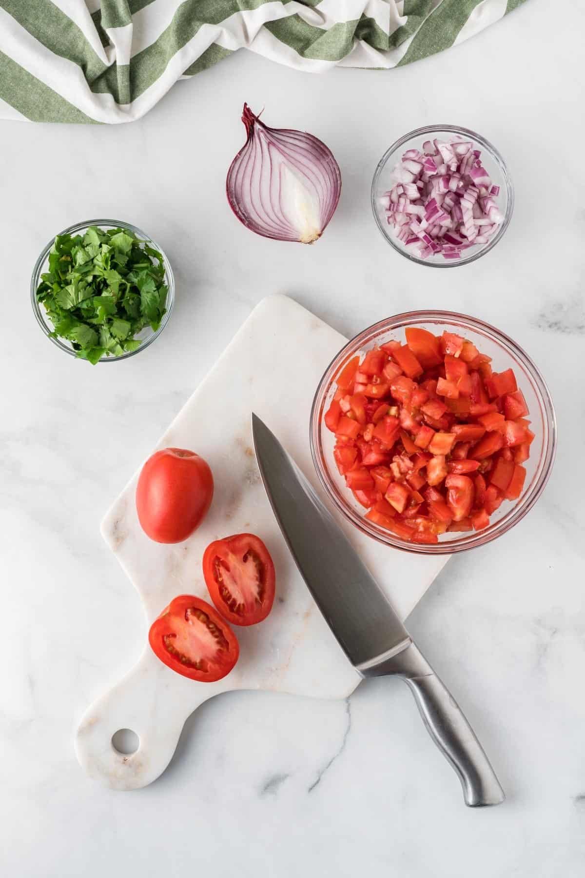 cutting tomatoes on a cutting board