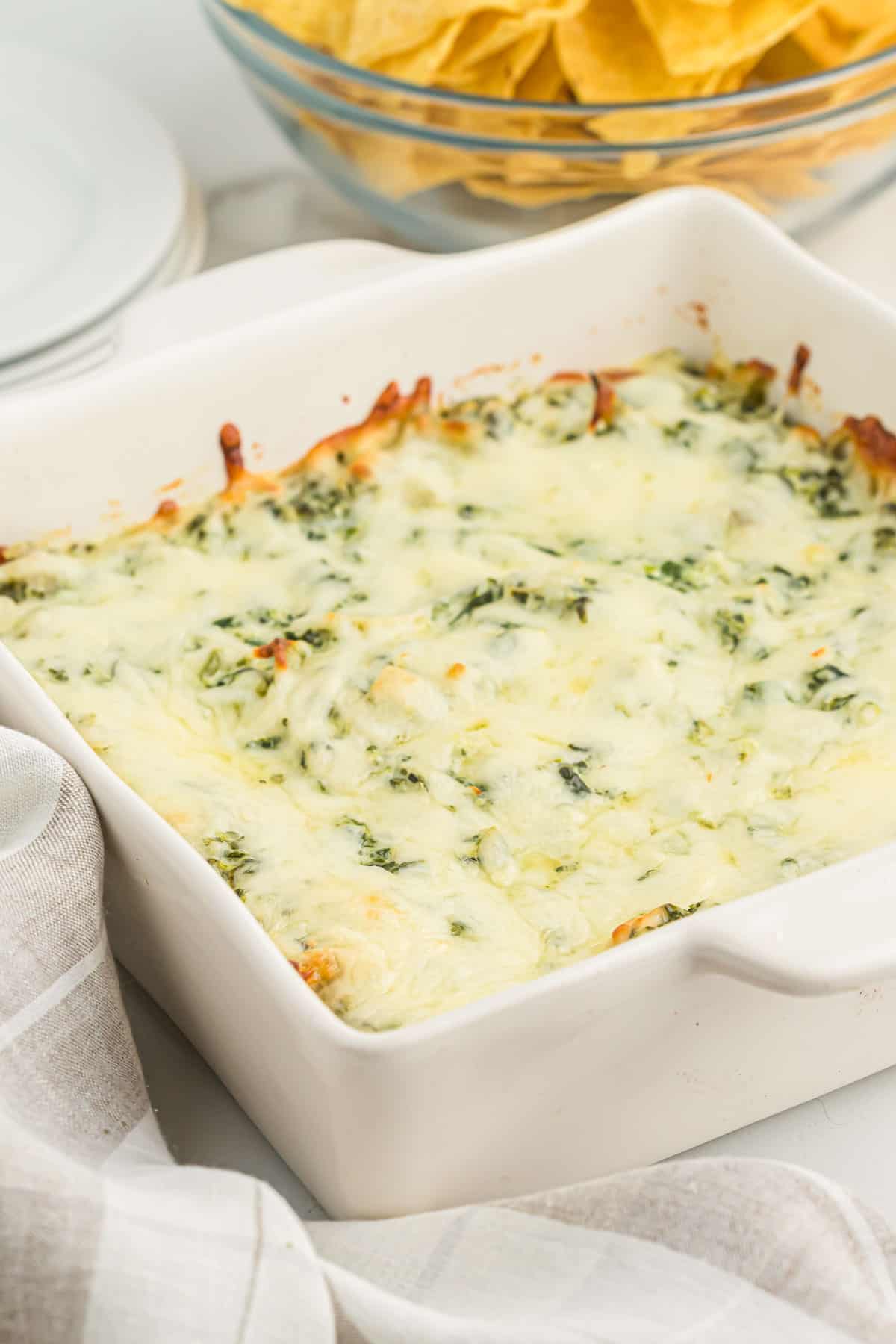 baked spinach artichoke dip in a white dish