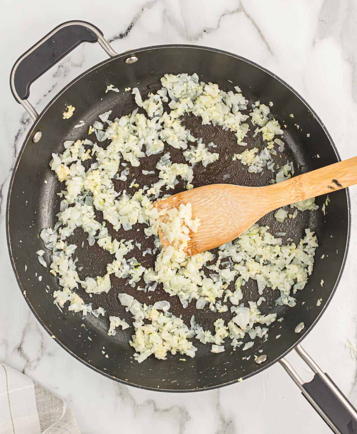 cooking garlic and onion in a skillet