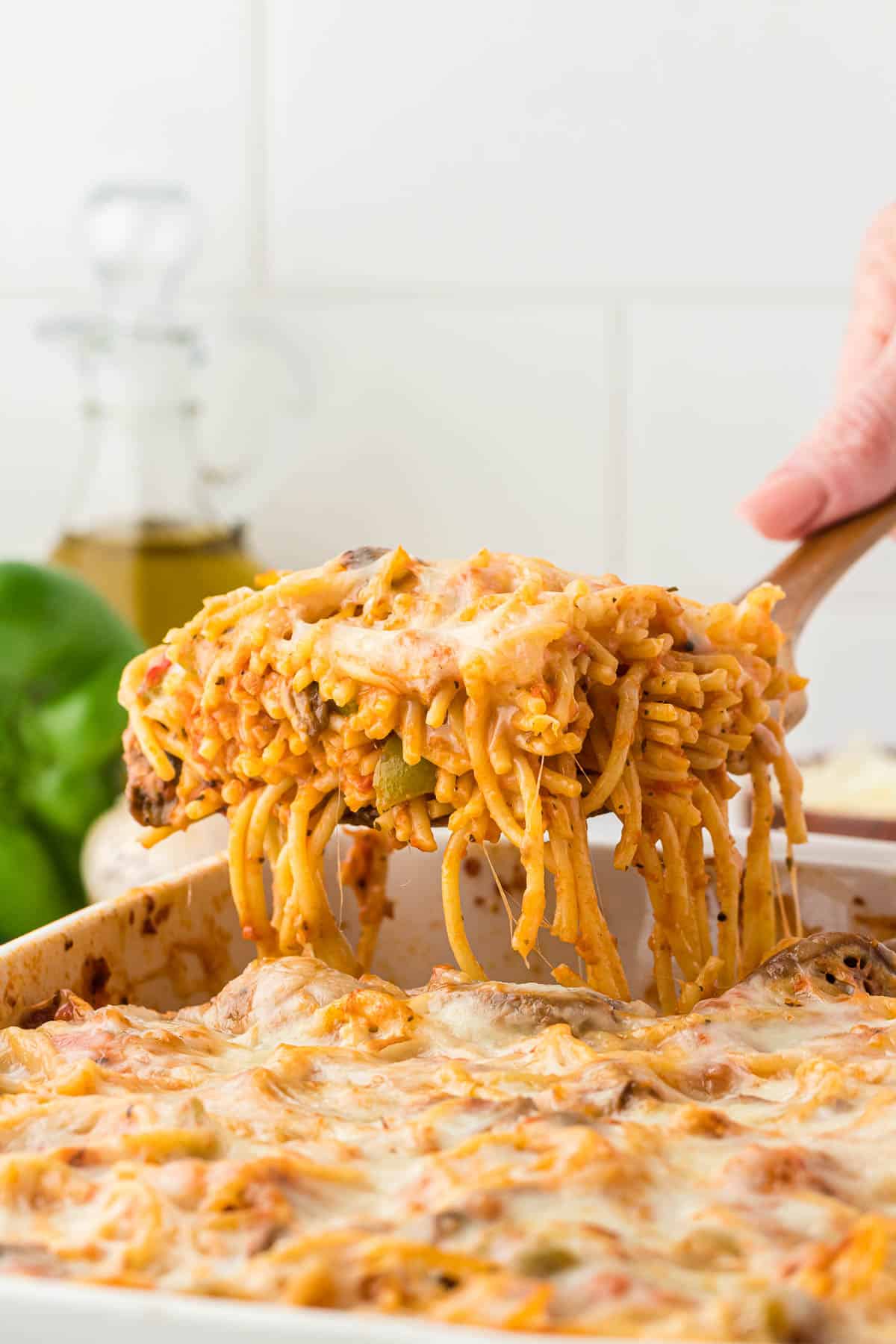 taking a serving of spaghetti bake from the dish