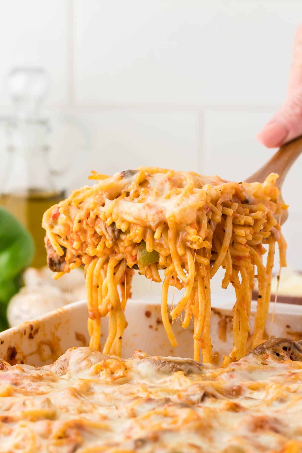 taking a serving of spaghetti bake from the dish