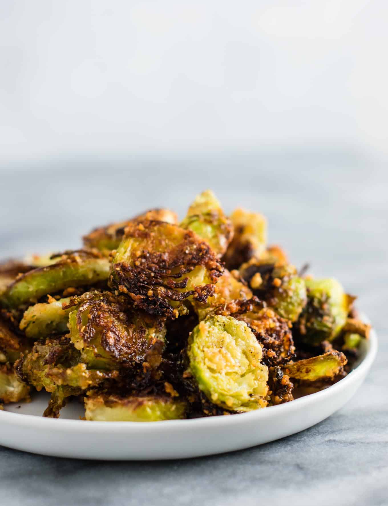 Roasted Brussel sprout chips - these are so good I could eat the whole pan myself! #brusselsprouts #brusselsproutchips #dinner #sidedish #vegetarian