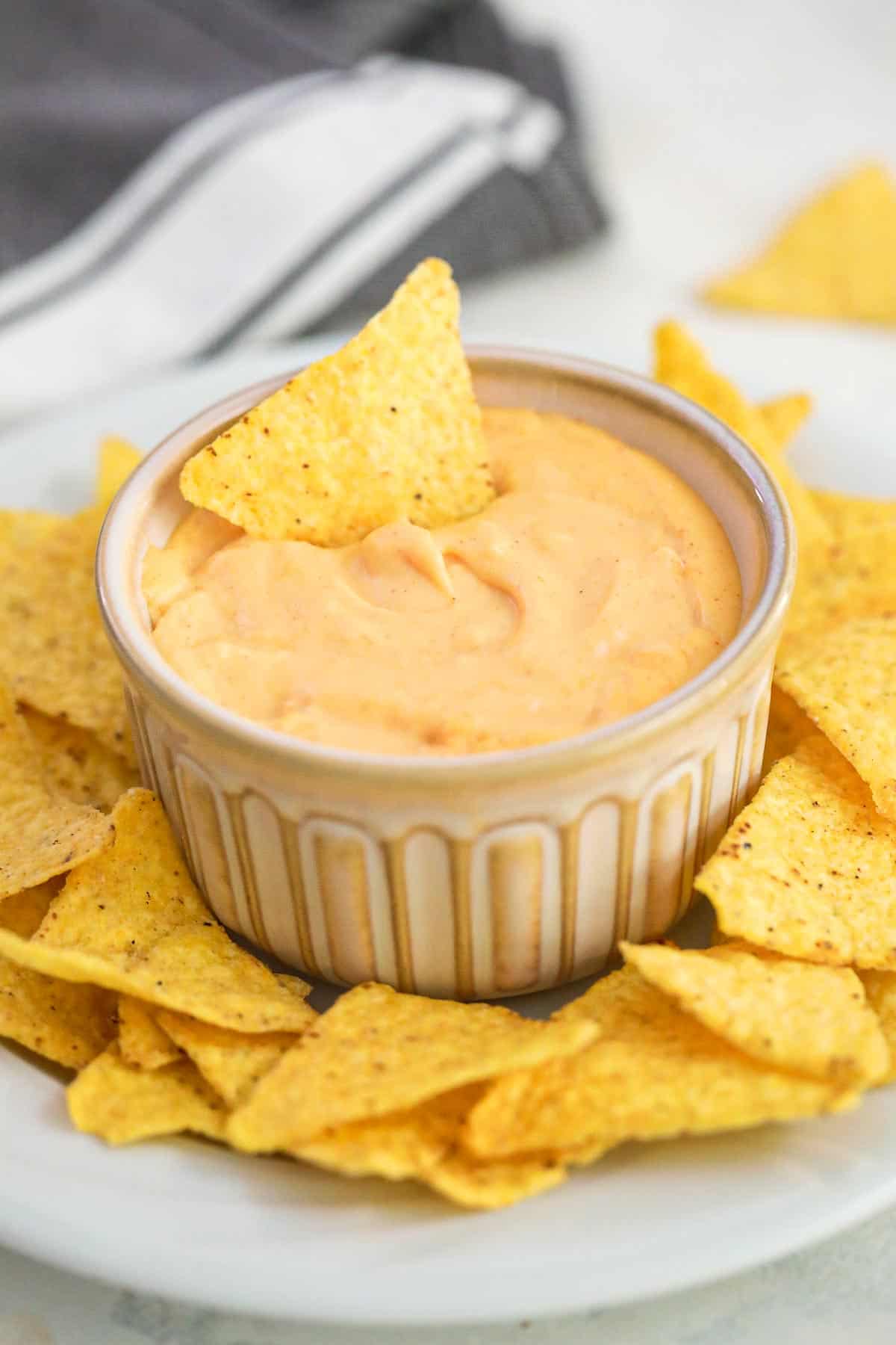 a chip placed in the nacho cheese