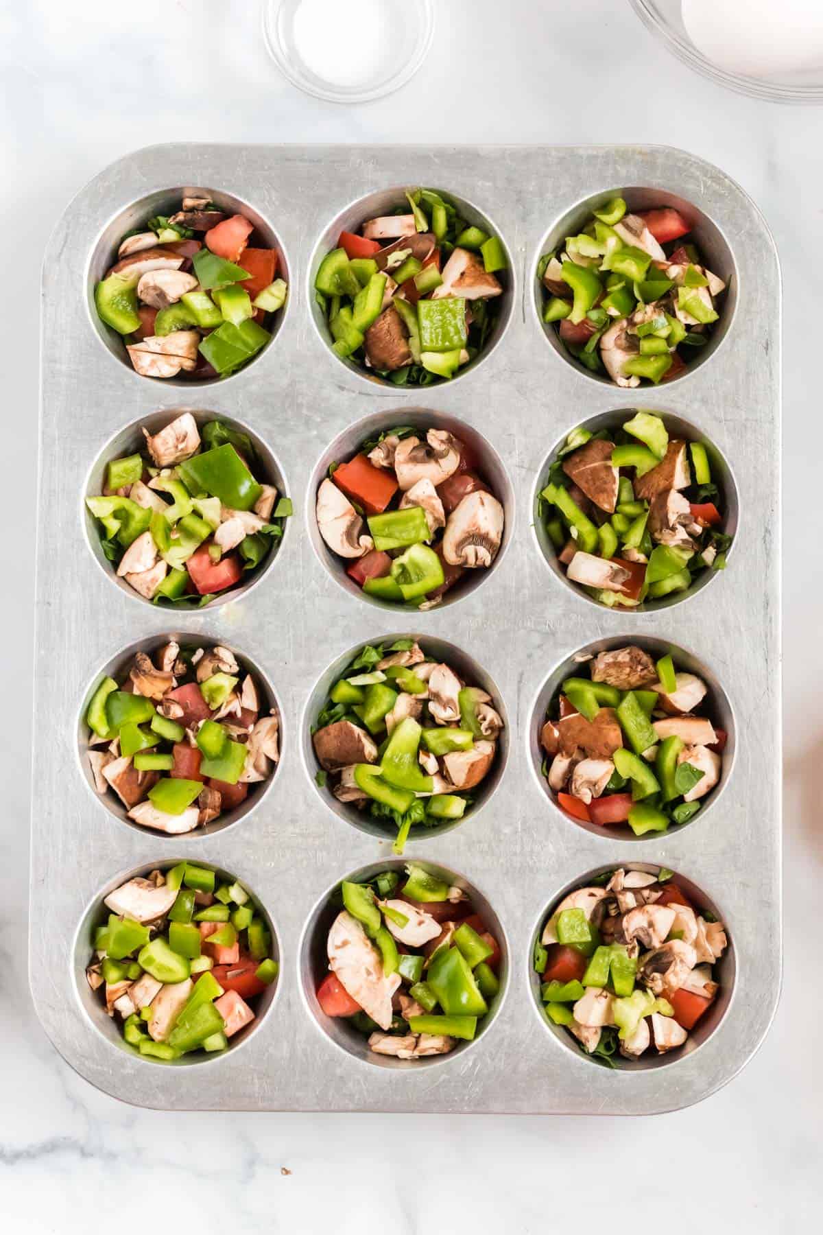 cut up veggies inside a muffin tin