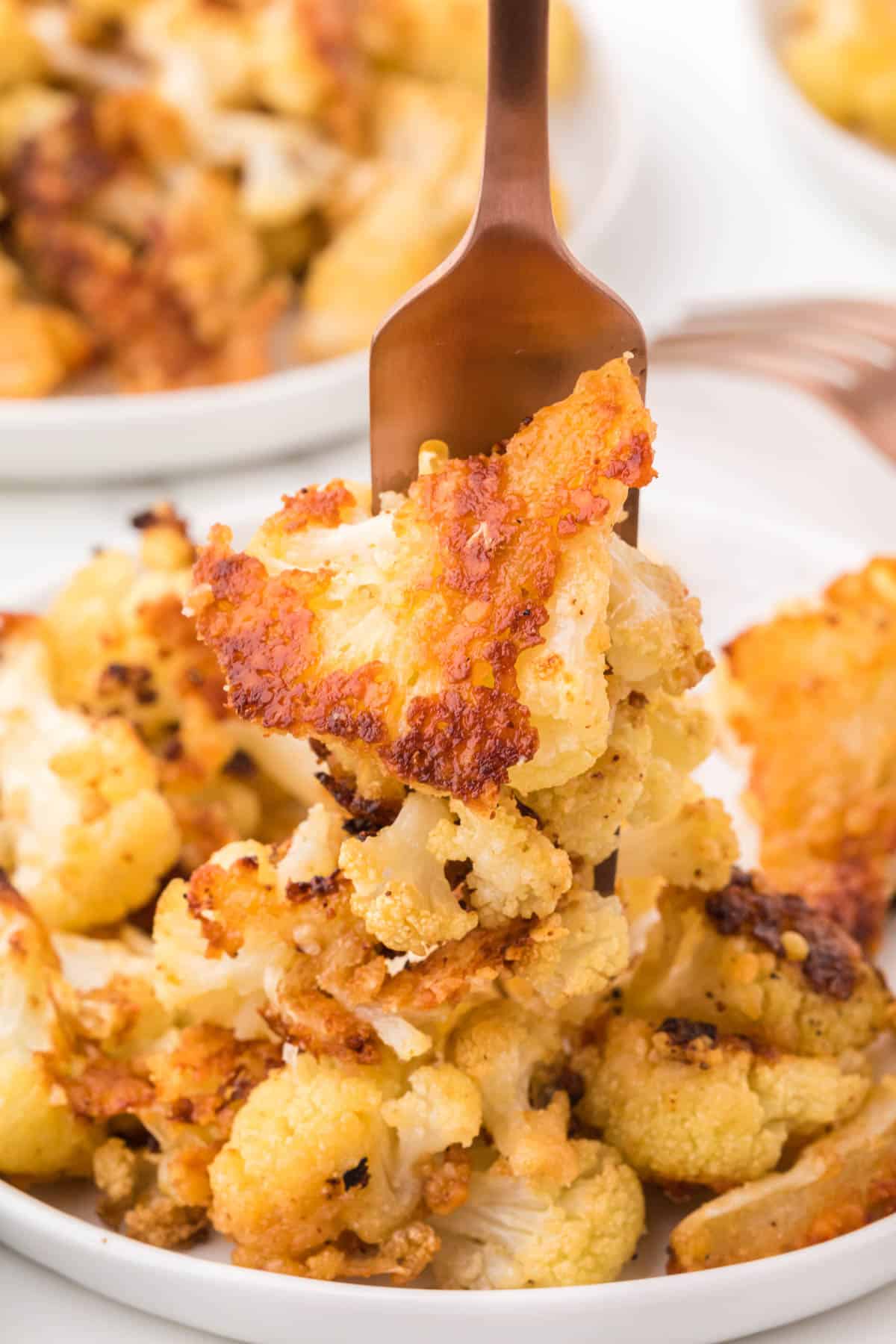 fork piercing a piece of cauliflower