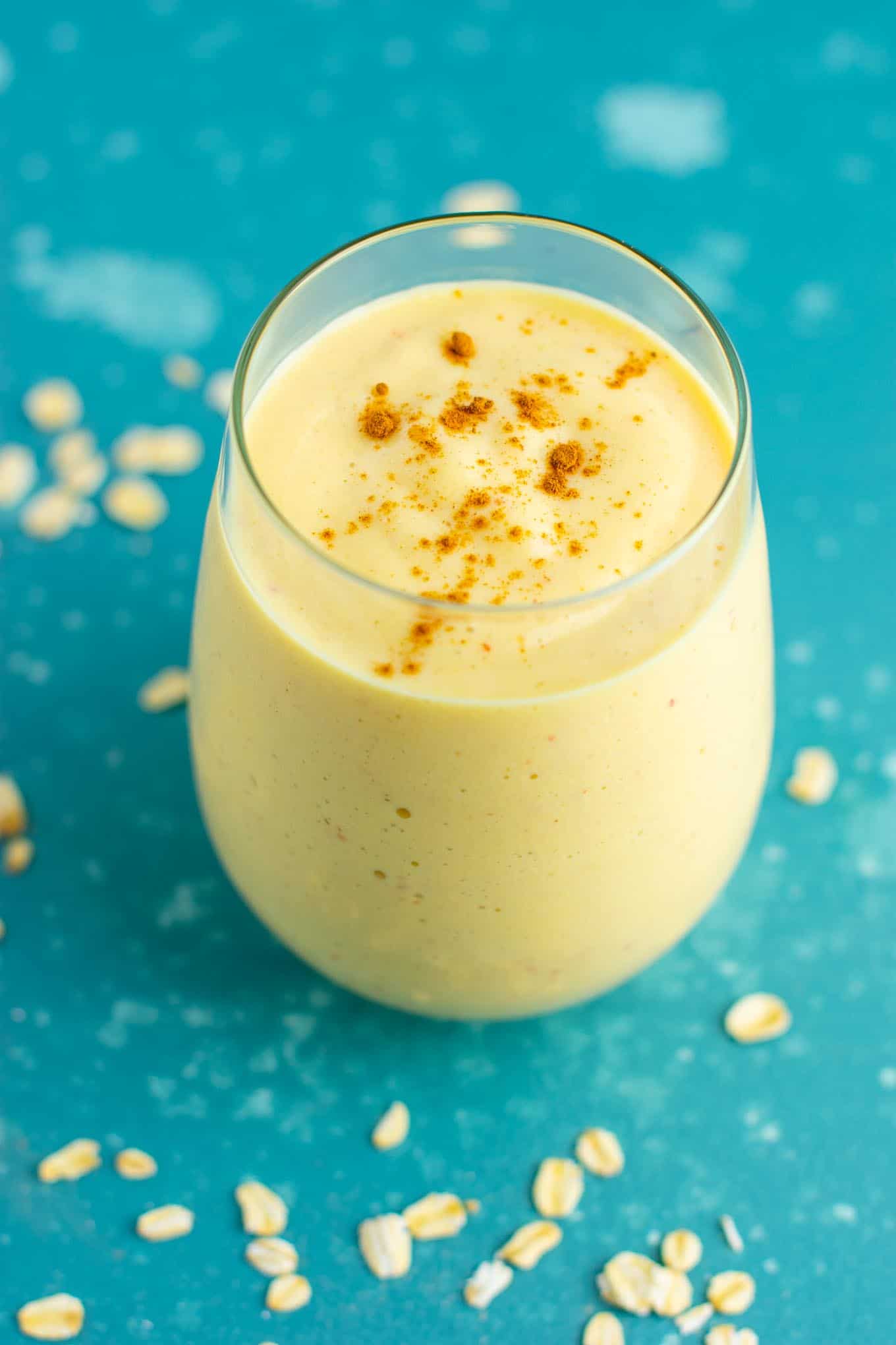 Healthy peach smoothie in a glass sprinkled with cinnamon