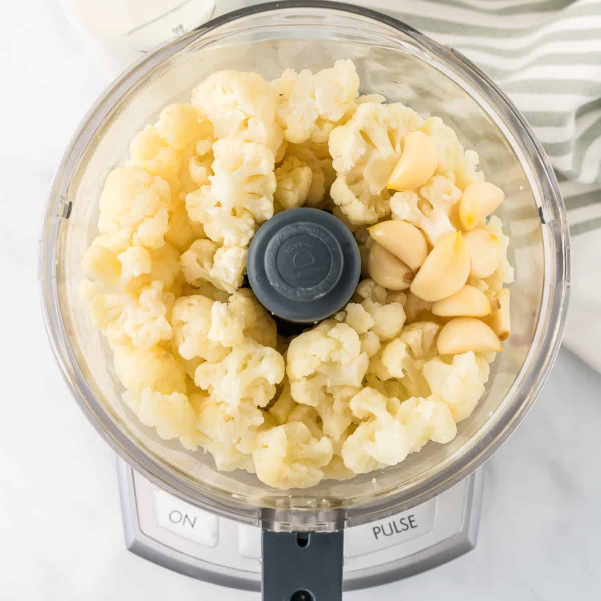 steamed cauliflower and garlic in a food processor