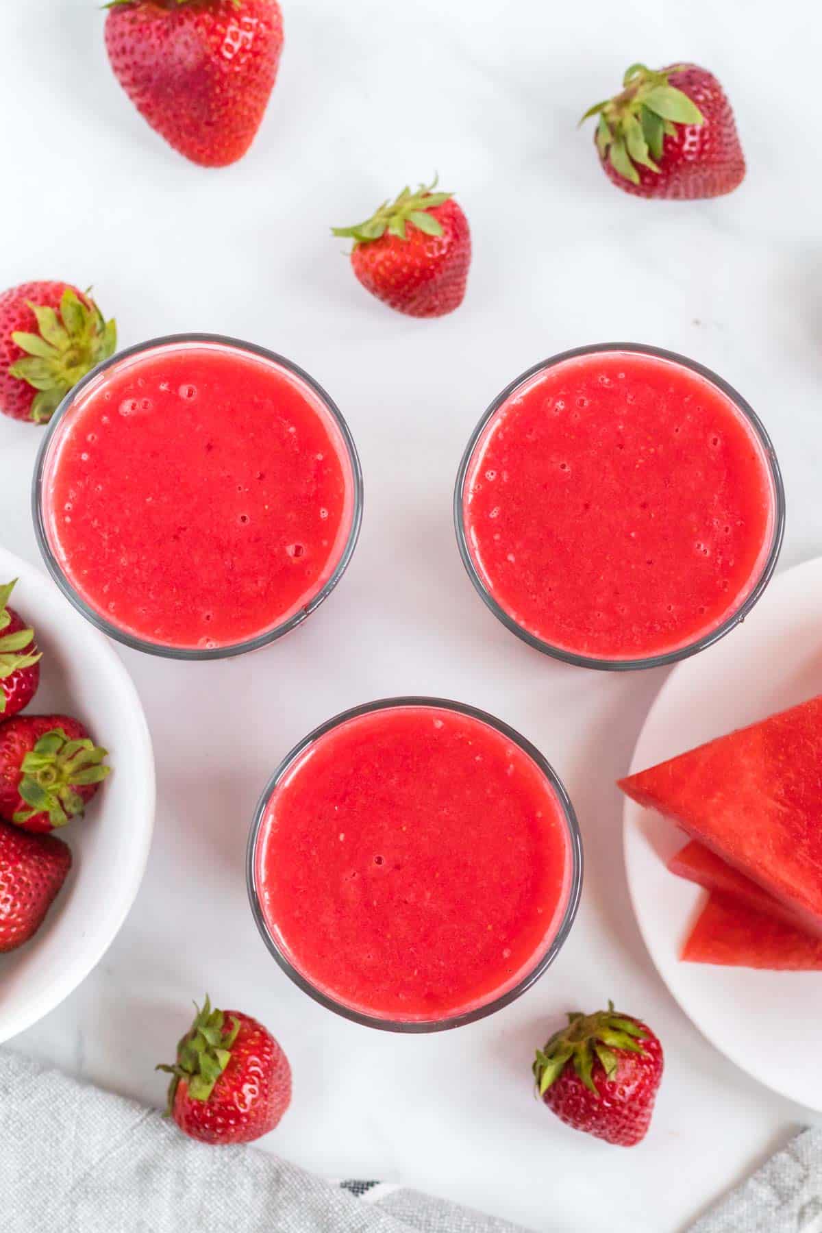 3 watermelon strawberry smoothies from an overhead view