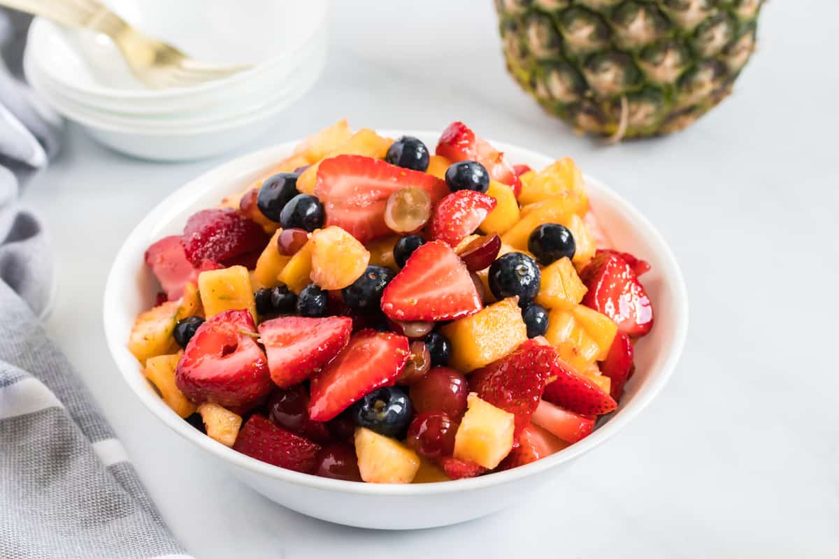 fruit salad in a small white serving bowl