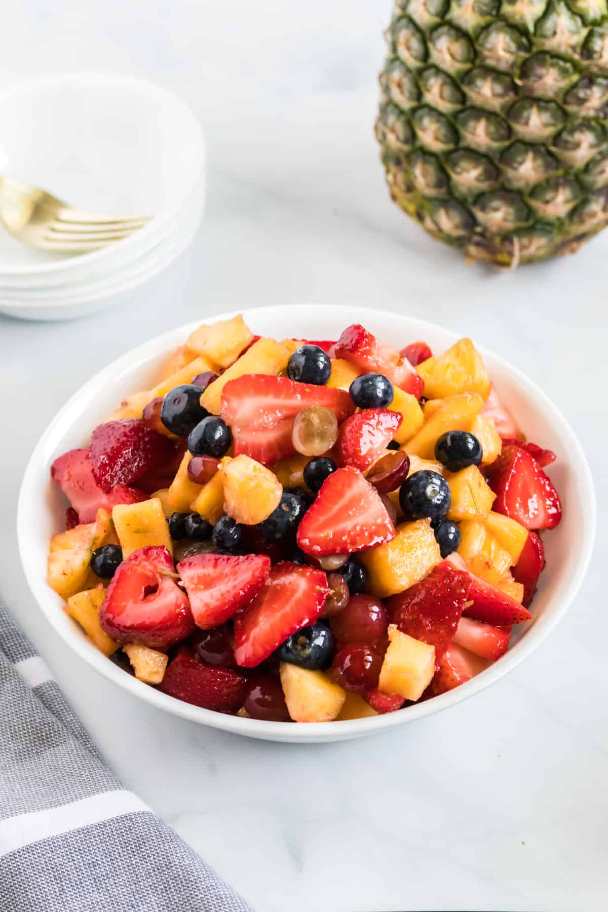 fruit salad in a small white serving bowl