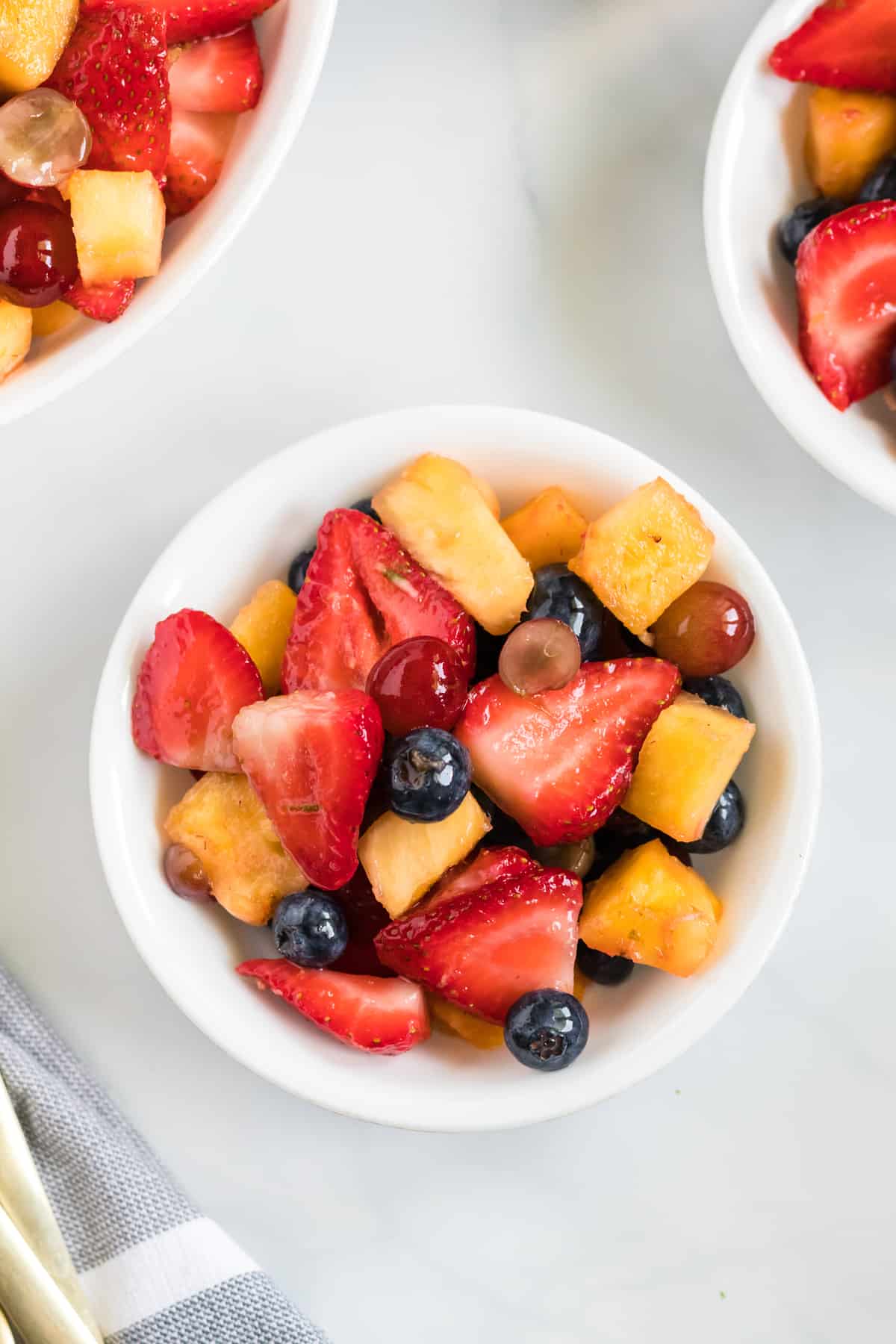 fruit salad in a small white serving bowl