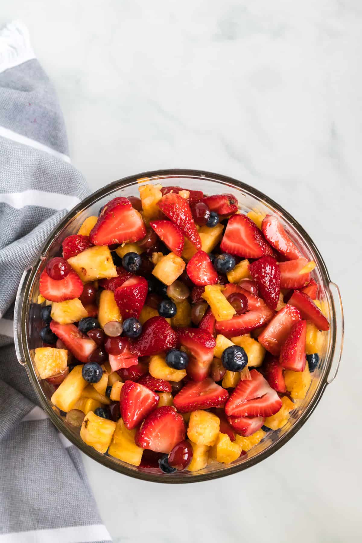 simple fruit salad recipe with honey lime dressing in a glass bowl