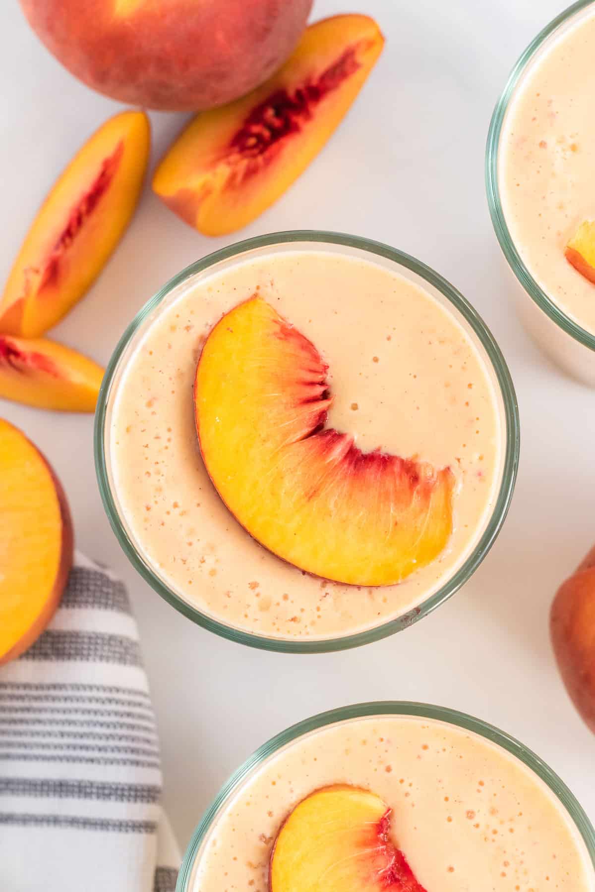 peach smoothies topped with peach slices
