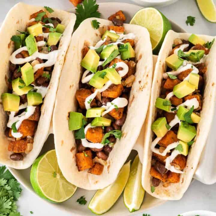 sweet potato tacos topped with sour cream and diced avocado