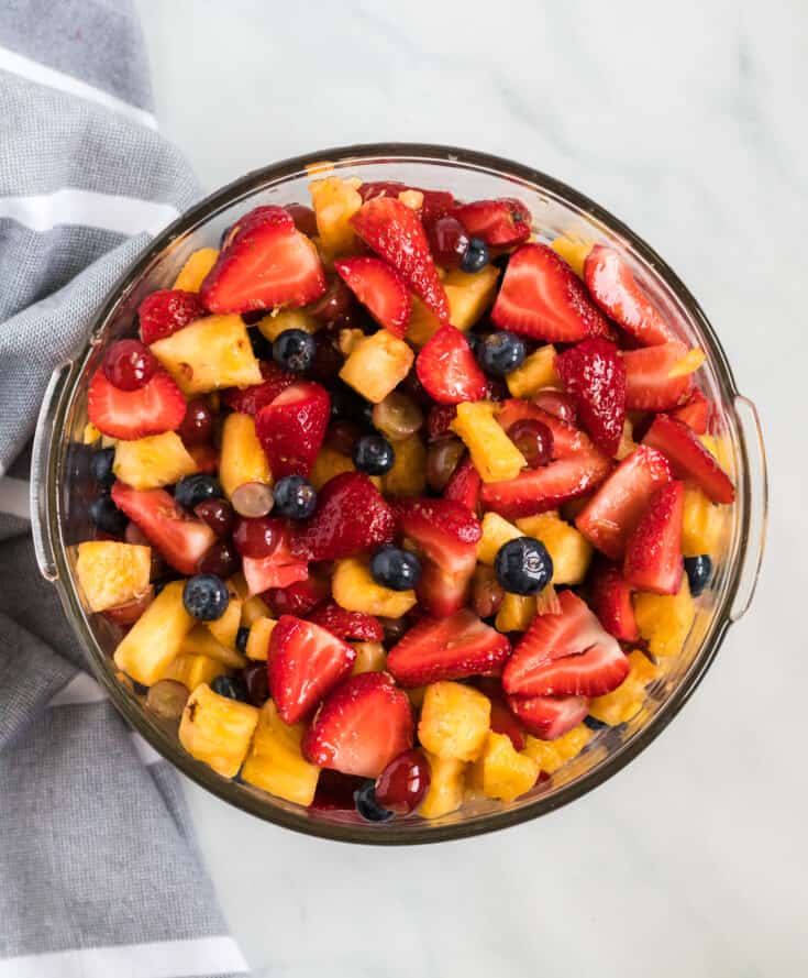 simple fruit salad recipe with honey lime dressing in a glass bowl