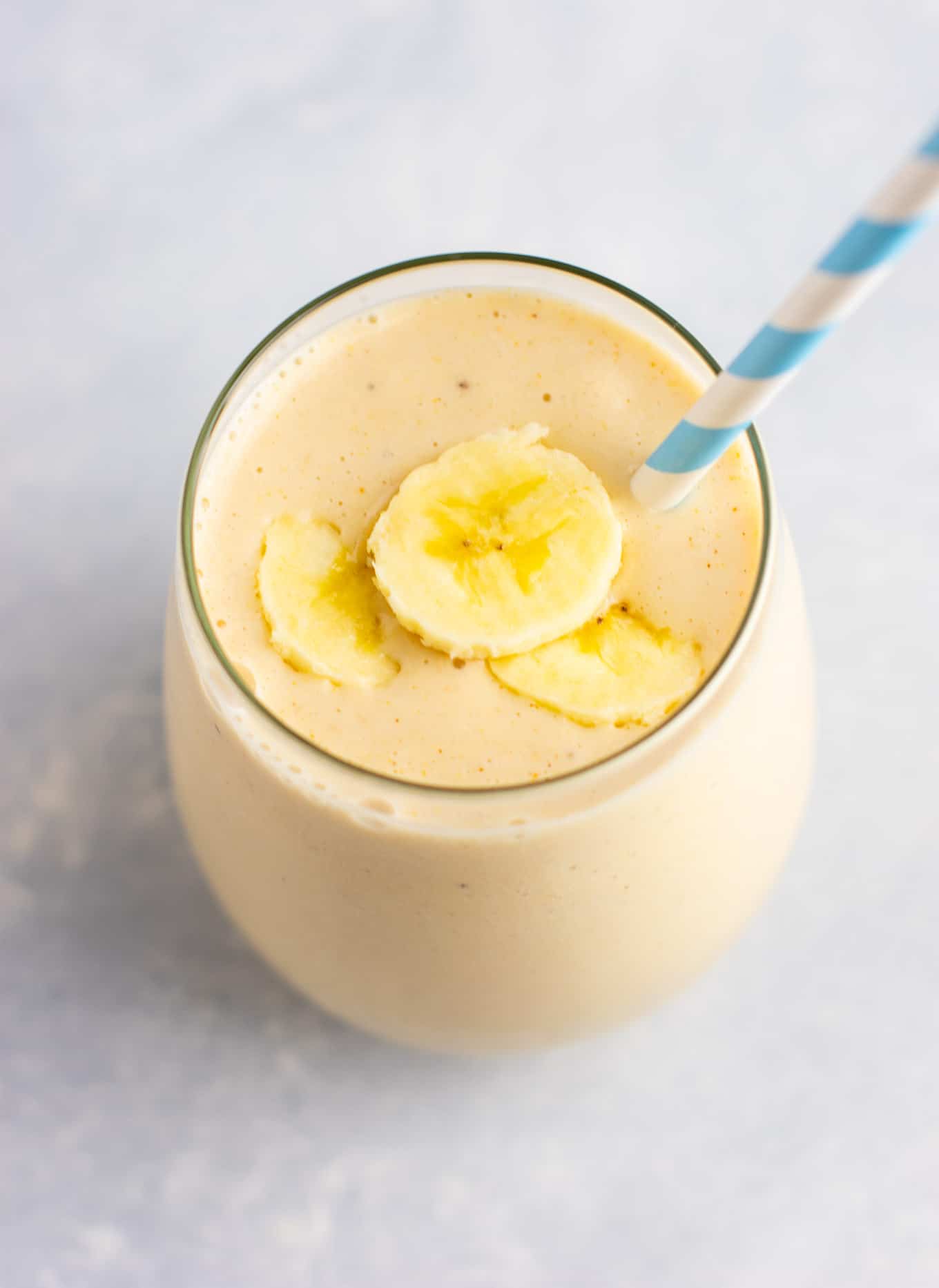 peanut butter banana smoothie topped with sliced banana