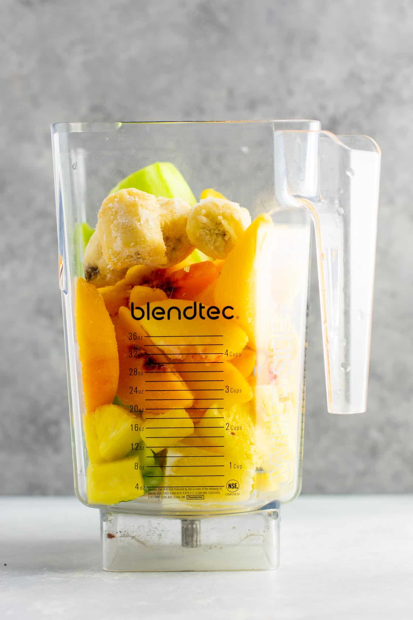 Pineapple detox smoothie with cucumbers, celery, lemon, peaches, ginger, and frozen bananas. A healthy smoothie recipe that tastes delicious! #detox #detoxsmoothie #healthysmoothie #vegan #healthyeating #healthyrecipe #smoothie #vegansmoothie