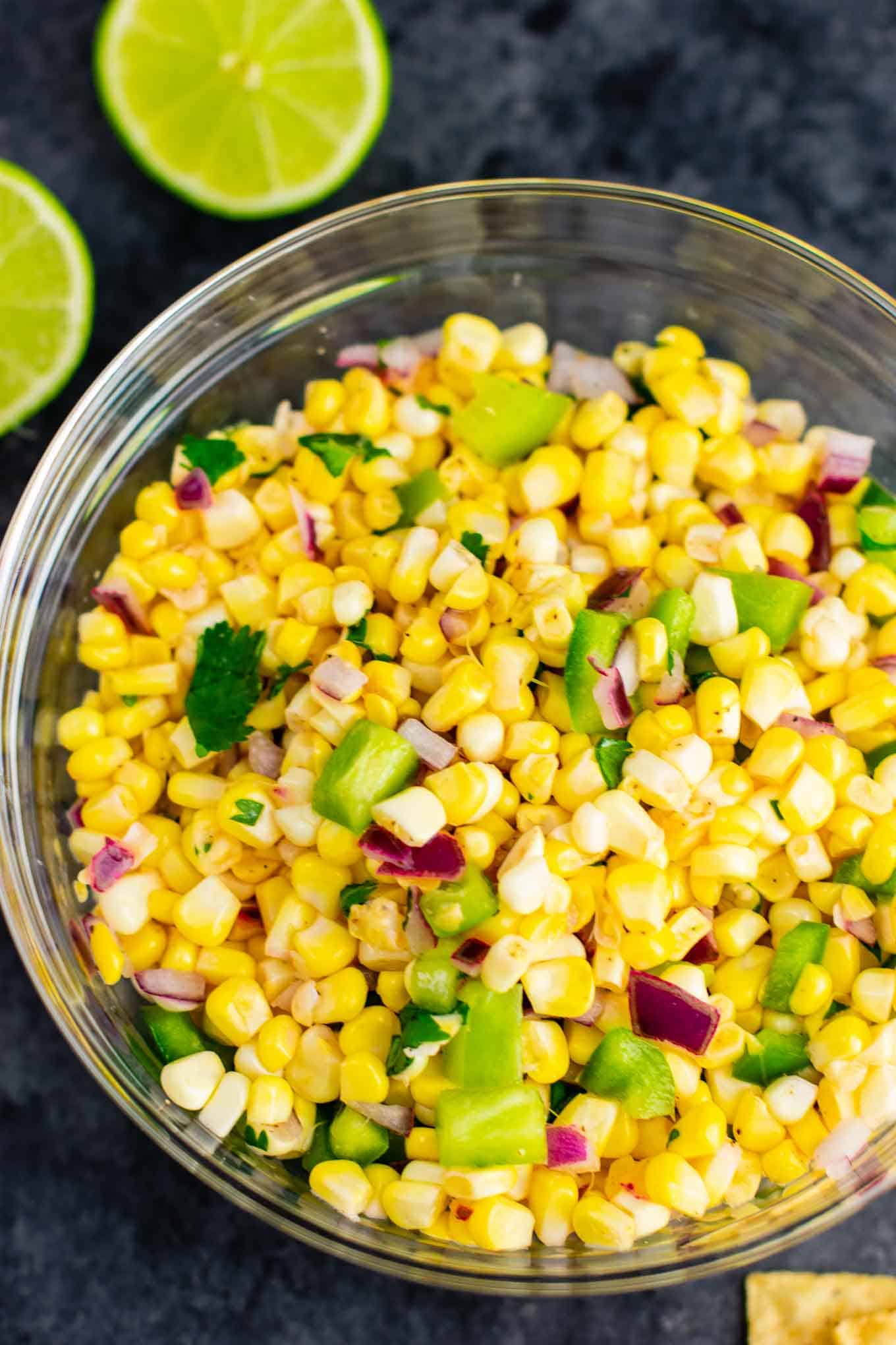 The best easy fresh corn salsa recipe made with just a few ingredients. It tastes better than chipotle and is ready in minutes! Make your own burrito bowls at home with this awesome corn salsa. #chipotlecornsalsa #cornsalsa #chipotle #burritobowl #appetizer #vegan #corn #appetizer