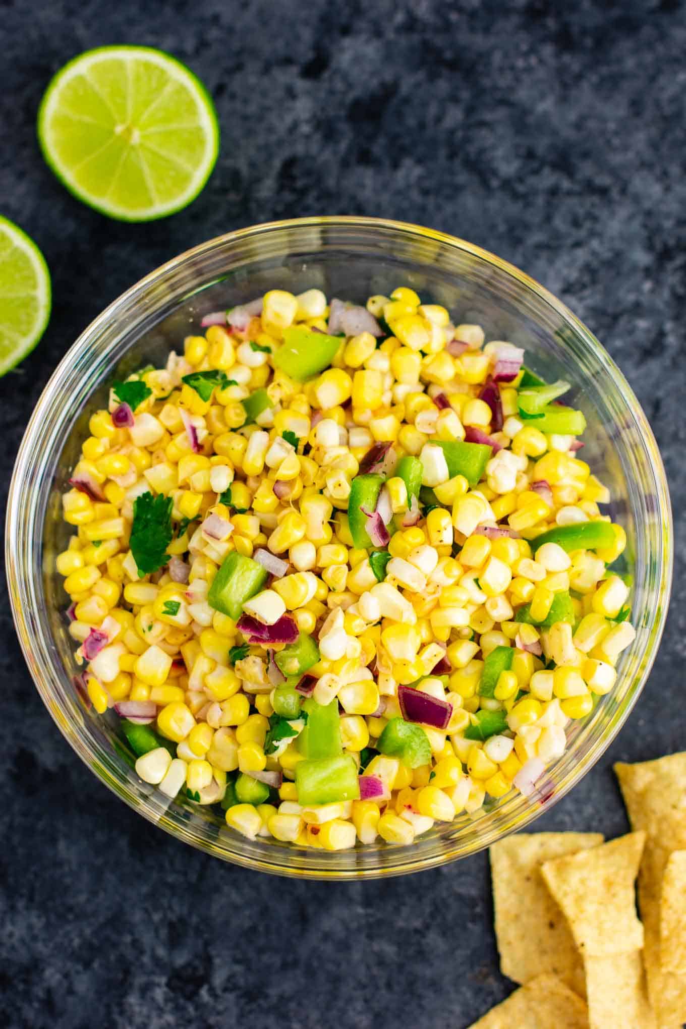 The best easy fresh corn salsa recipe made with just a few ingredients. It tastes better than chipotle and is ready in minutes! Make your own burrito bowls at home with this awesome corn salsa. #chipotlecornsalsa #cornsalsa #chipotle #burritobowl #appetizer #vegan #corn #appetizer