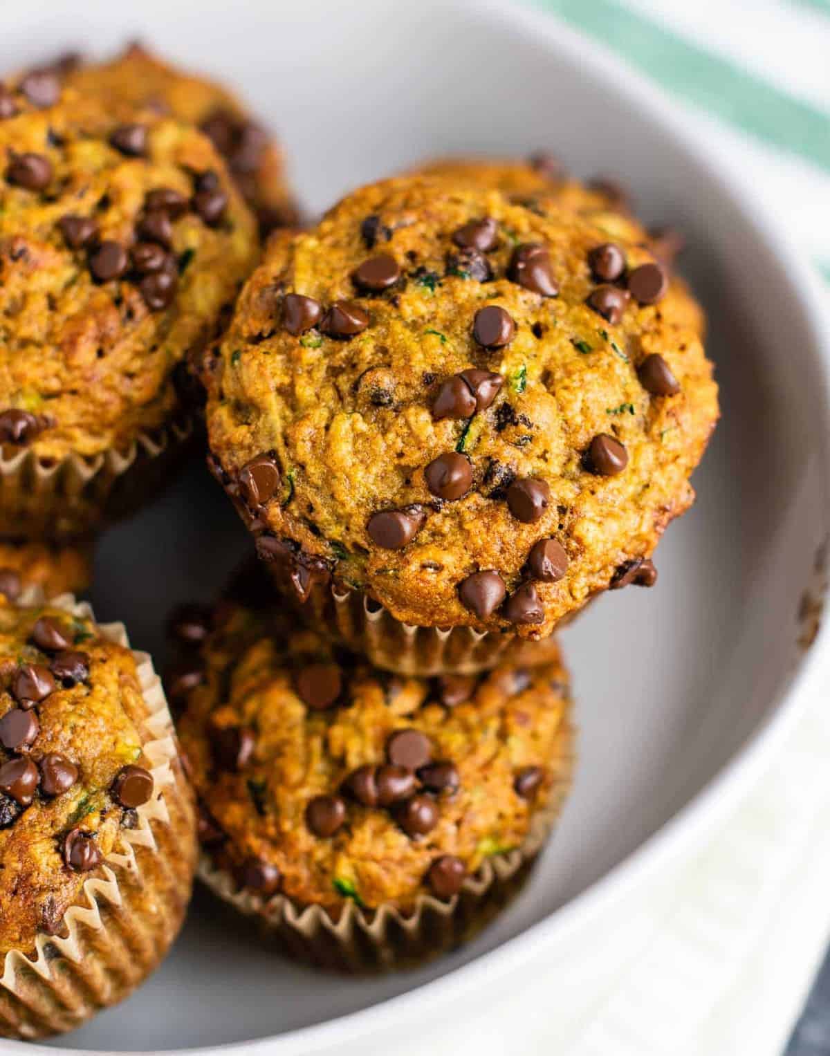 Healthy chocolate chip zucchini muffins made with easy ingredients. Perfect for using up all of that summer zucchini! #zucchini #muffins #chocolatechip #healthy #breakfast #vegetarian