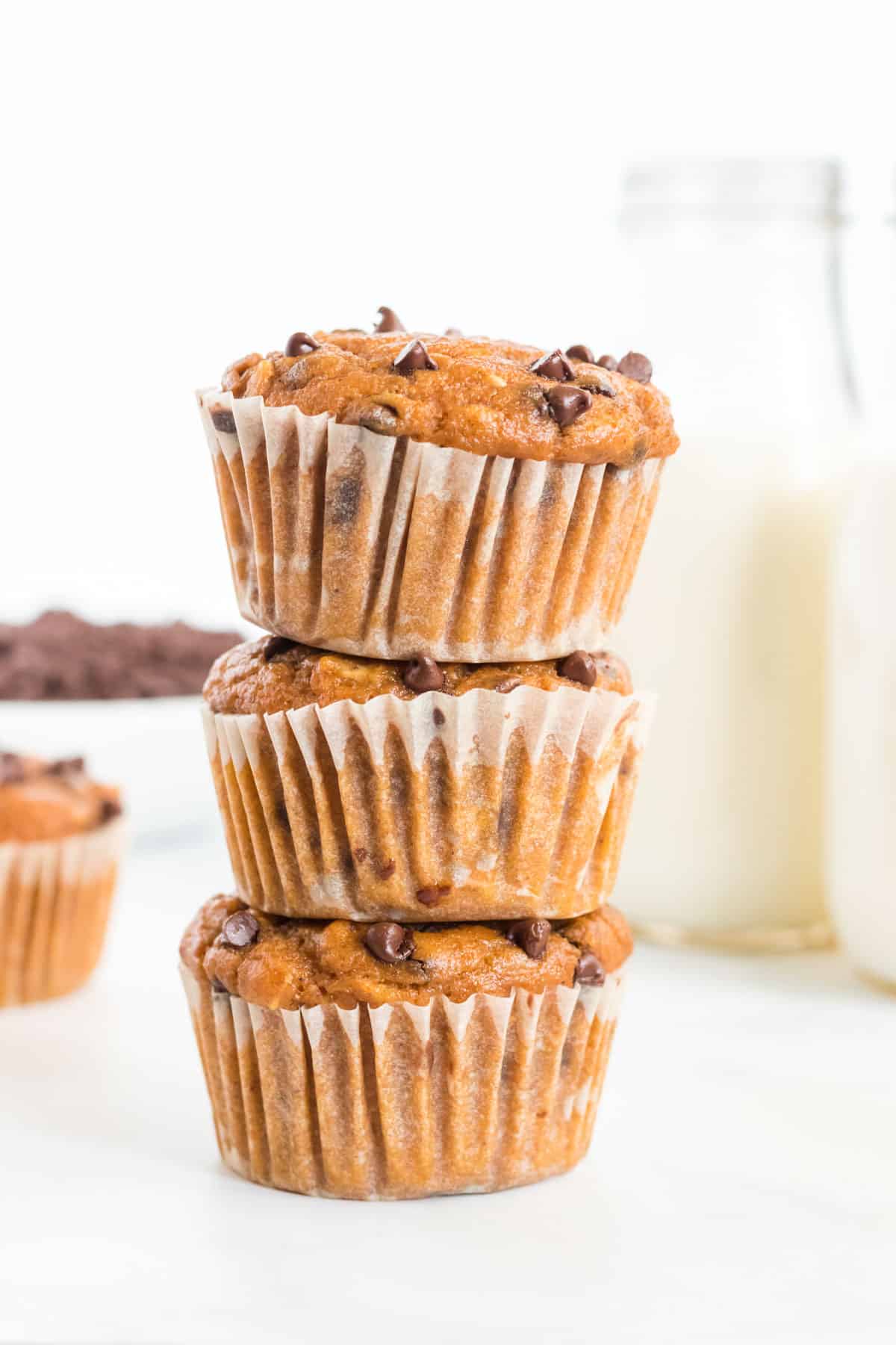 pumpkin chocolate chip muffins stacked on top of each other