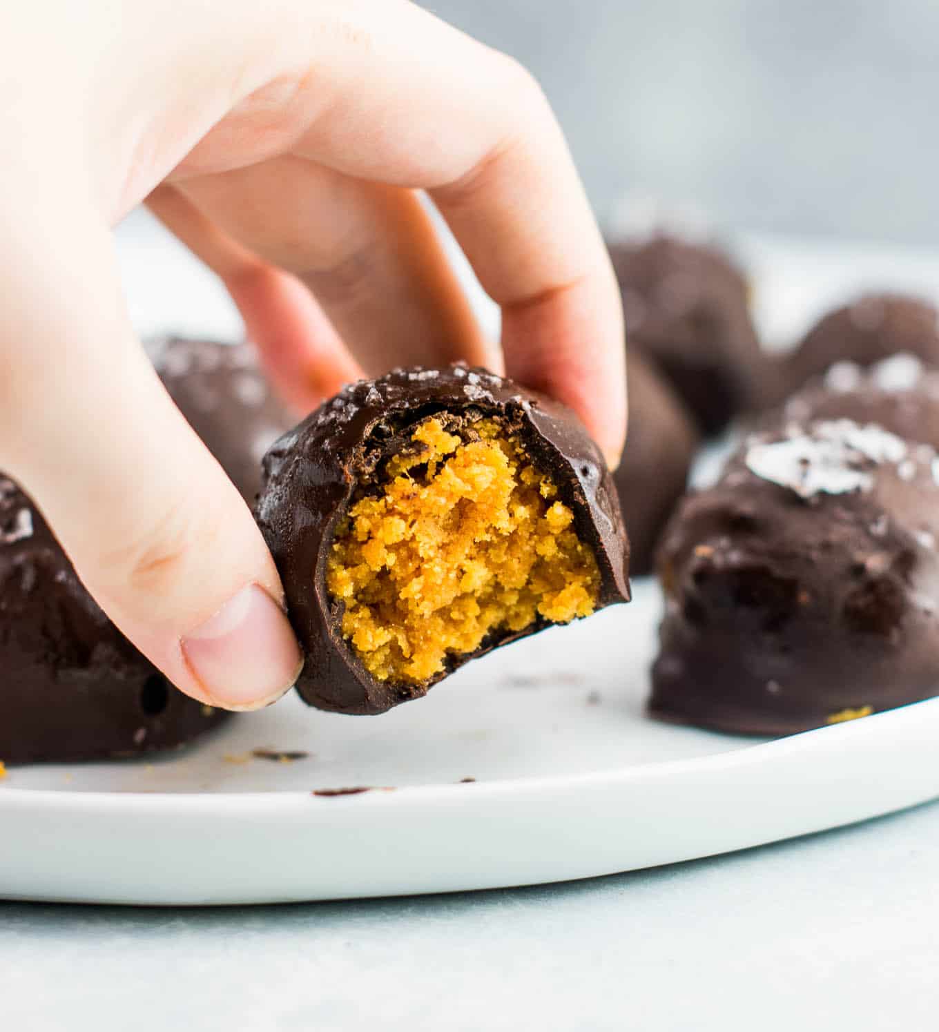 Dark chocolate pumpkin truffles recipe (vegan, gluten free) These taste AMAZING! Made with coconut flour and dark chocolate chunks. This needs to be your next pumpkin dessert! #pumpkintruffles #pumpkin #nobake #vegan #glutenfree #dessert