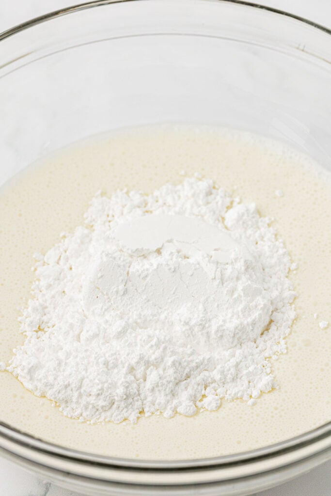 adding powdered sugar to heavy cream
