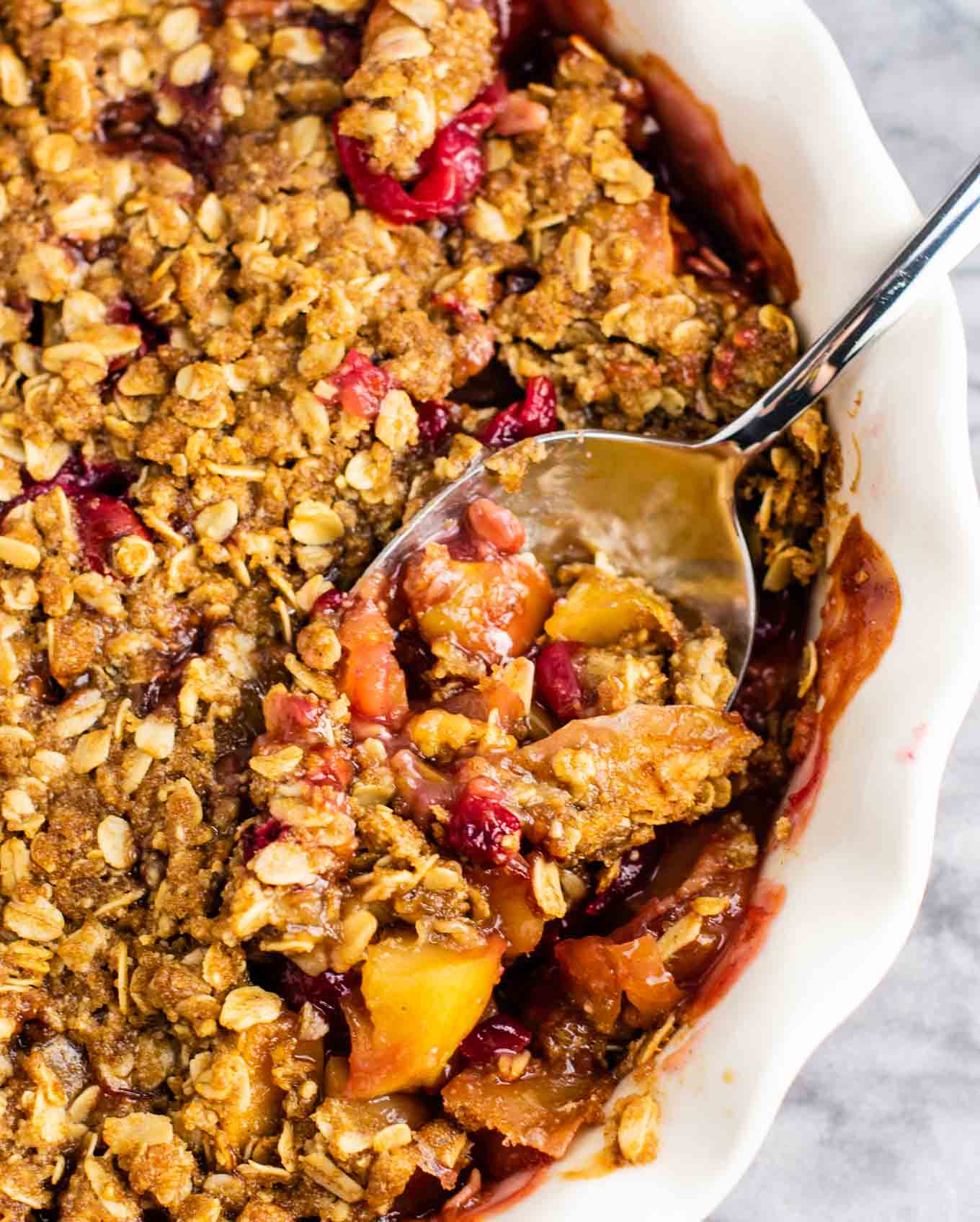 taking a spoon of cranberry apple crisp