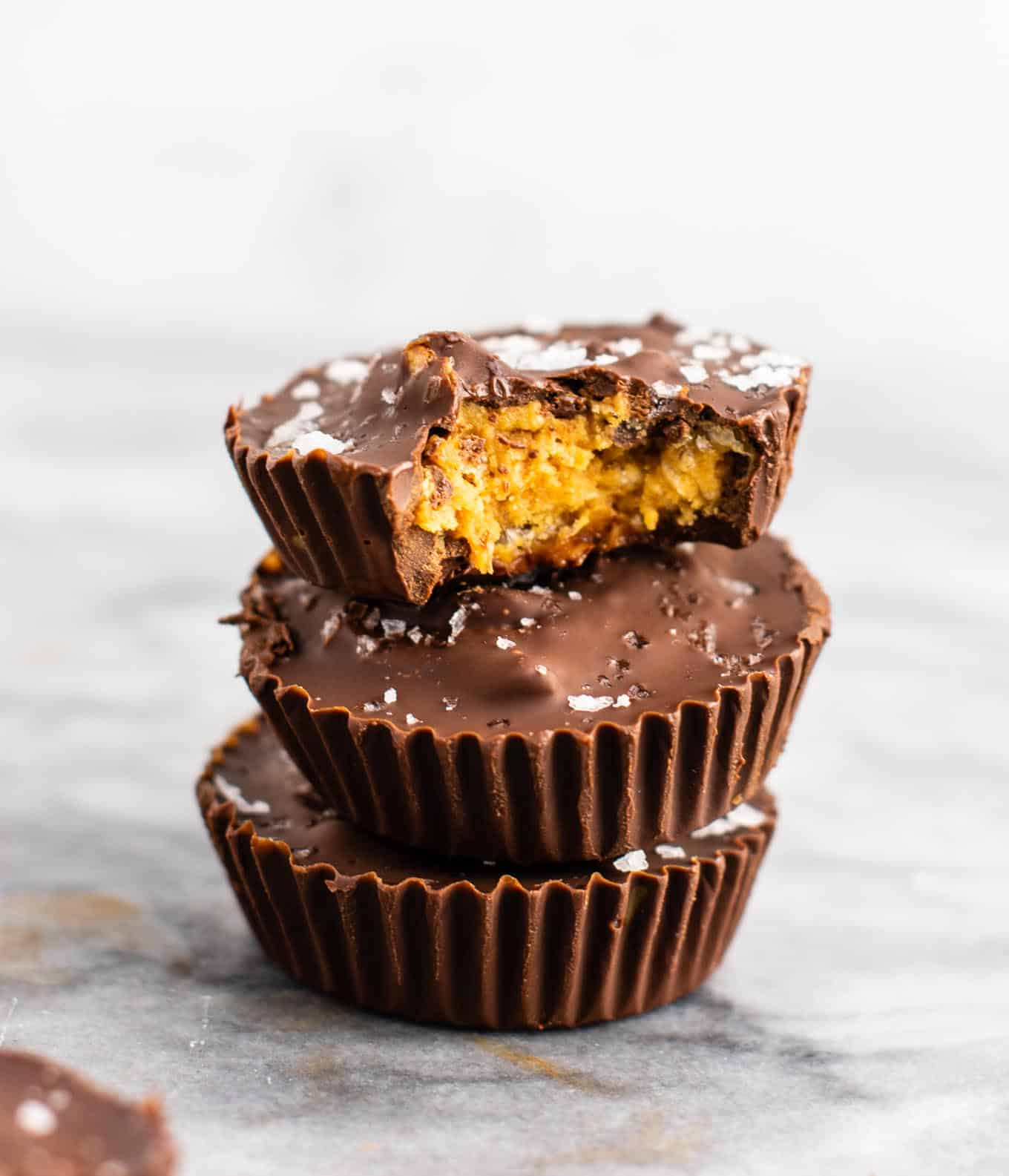 Chocolate peanut butter crunch cups with flaked sea salt – these are next level DELICIOUS! Vegan, gluten free, and tastes so good you won’t want to share! Perfect treat to keep in the freezer! #vegan #glutenfree #dessert #reesescups #vegandessert #glutenfreedessert #christmas #holidaytreat #seasalt