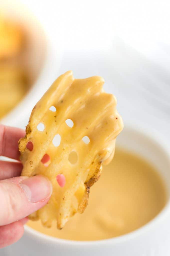 a waffle fry dipped in chick fil a sauce