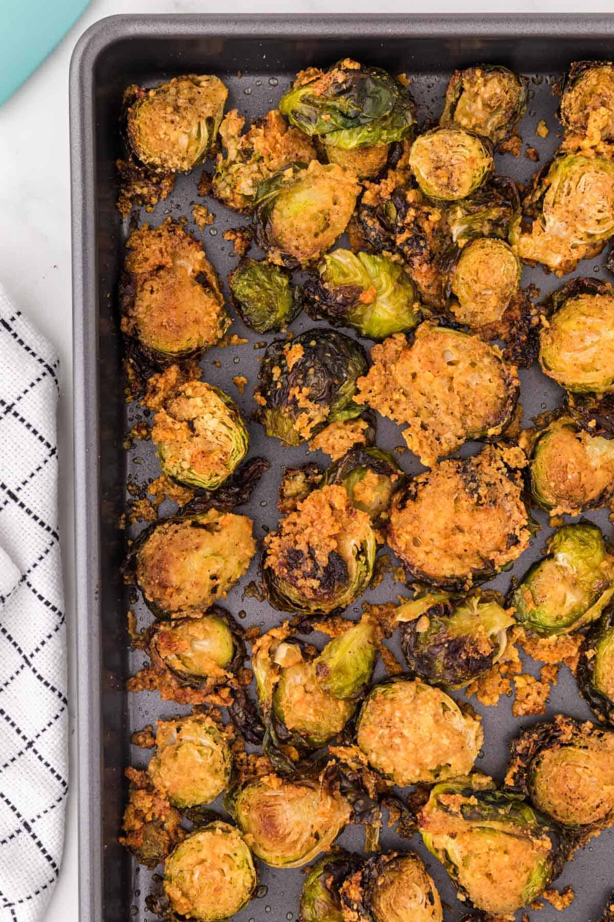crispy brussel sprout chips on a baking sheet
