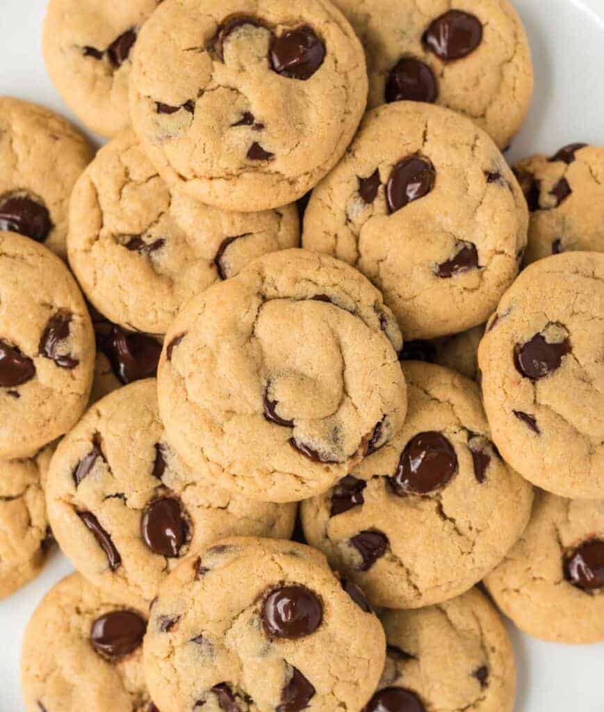vegan chocolate chip cookies stacked on a plate