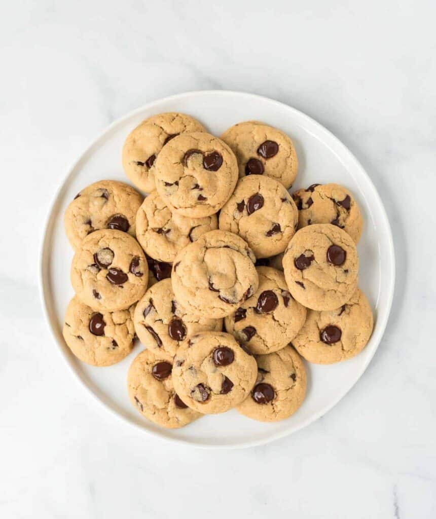 vegan chocolate chip cookies stacked on a plate