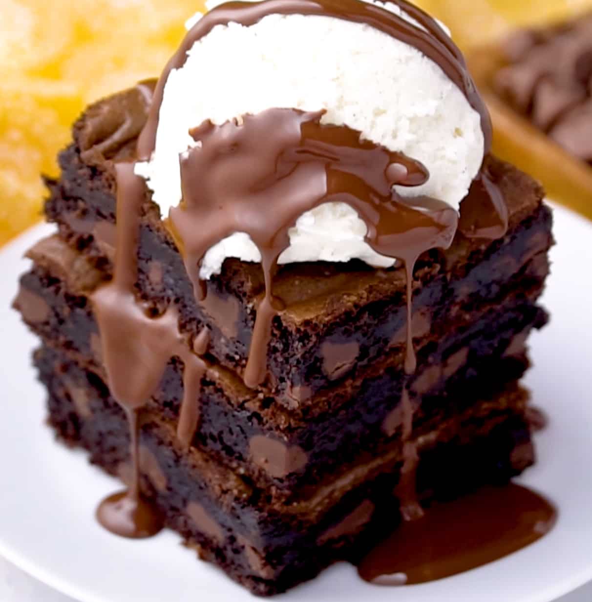 brownies topped with vanilla ice cream and fudge sauce