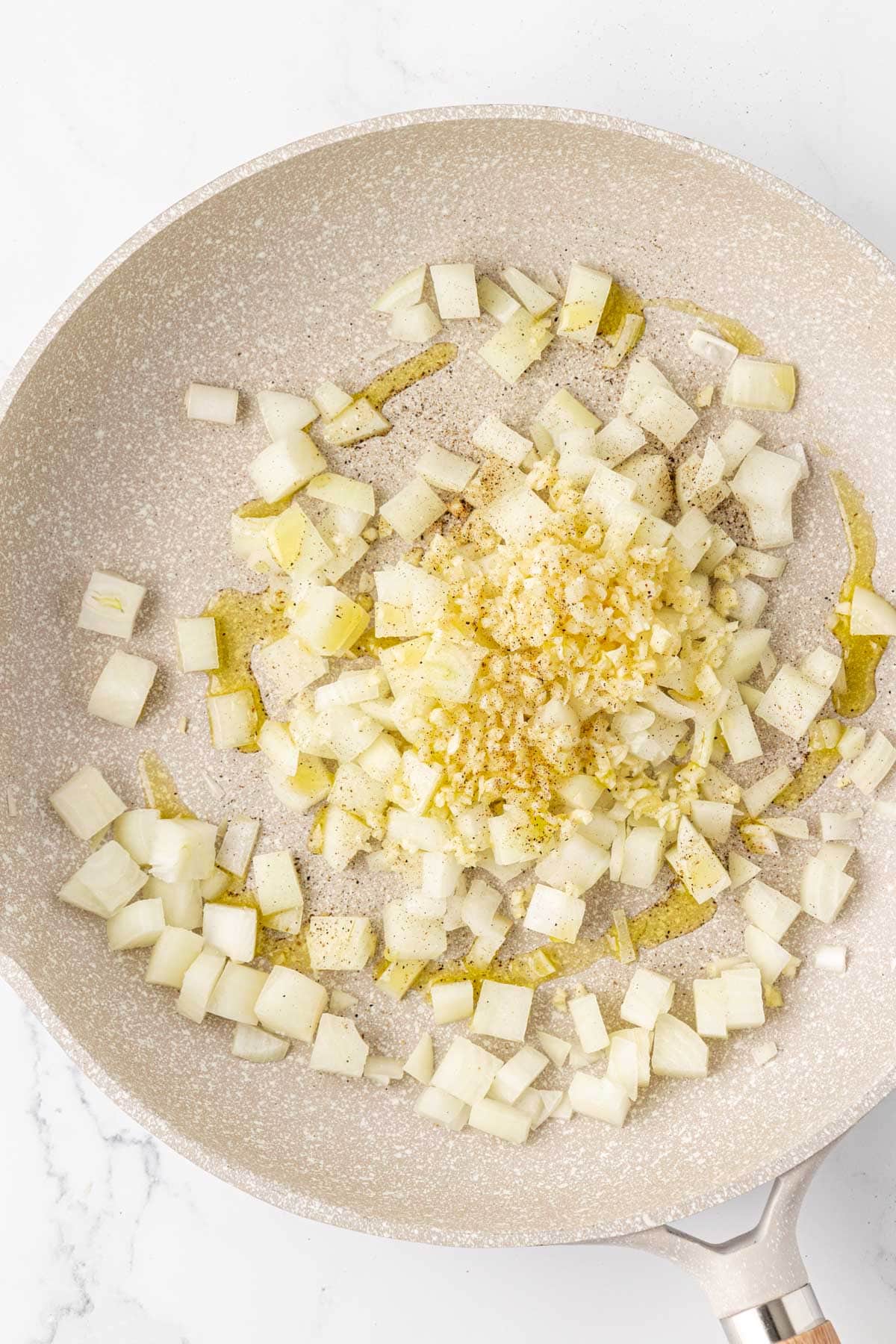 garlic and onion in a skillet with olive oil