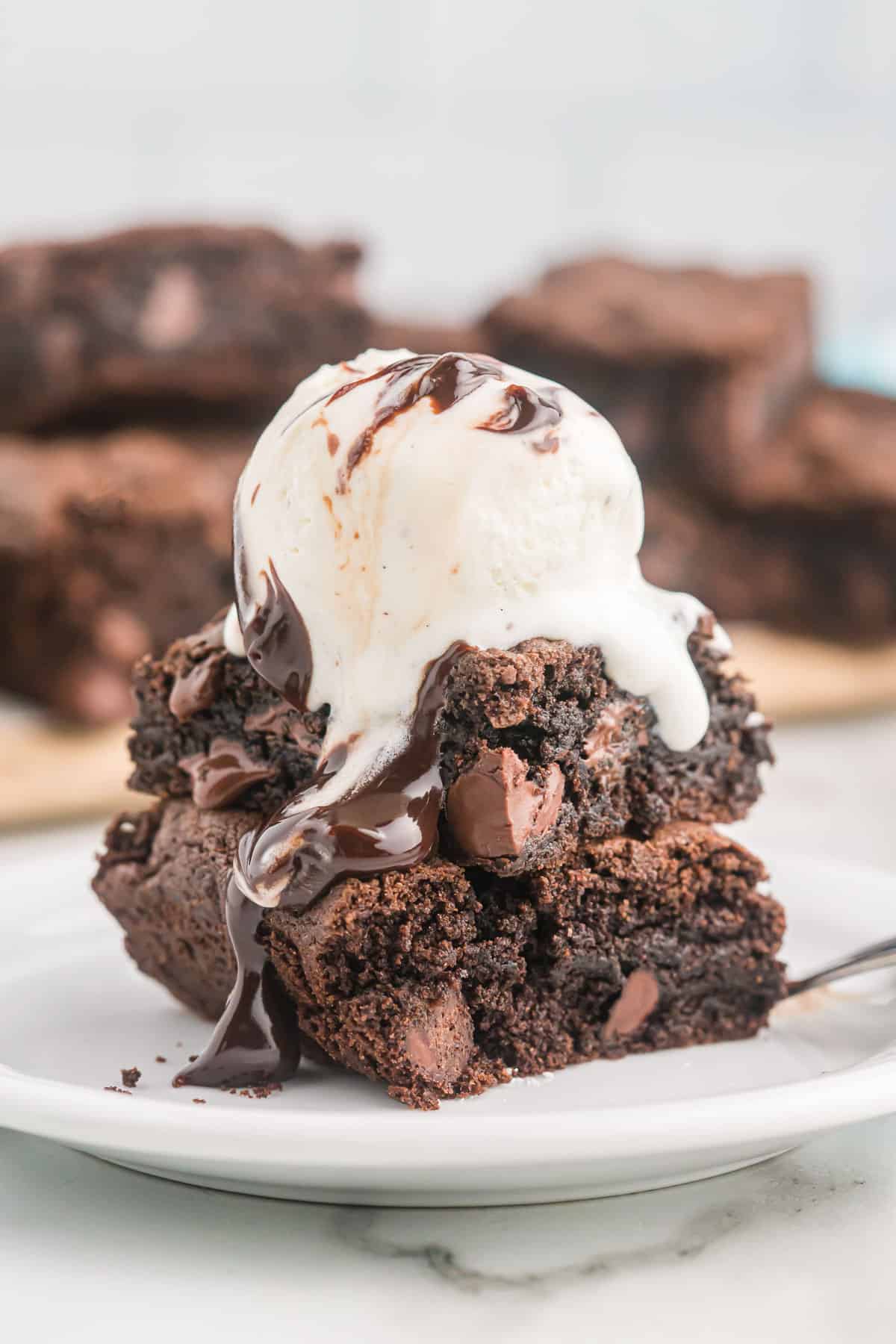 cake mix brownies topped with vanilla ice cream and chocolate syrup