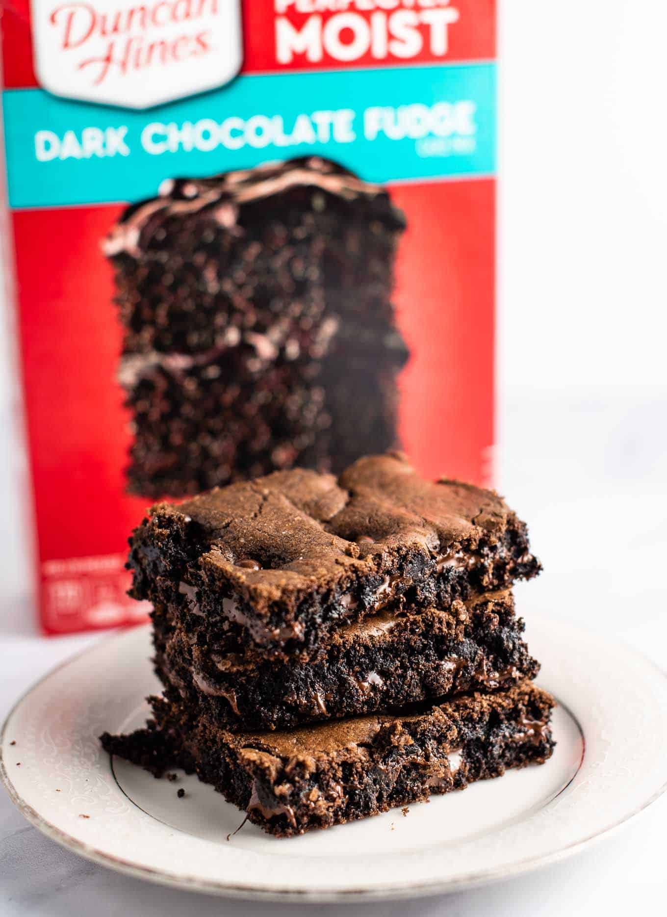 brownies on a plate with the cake mix box in the background