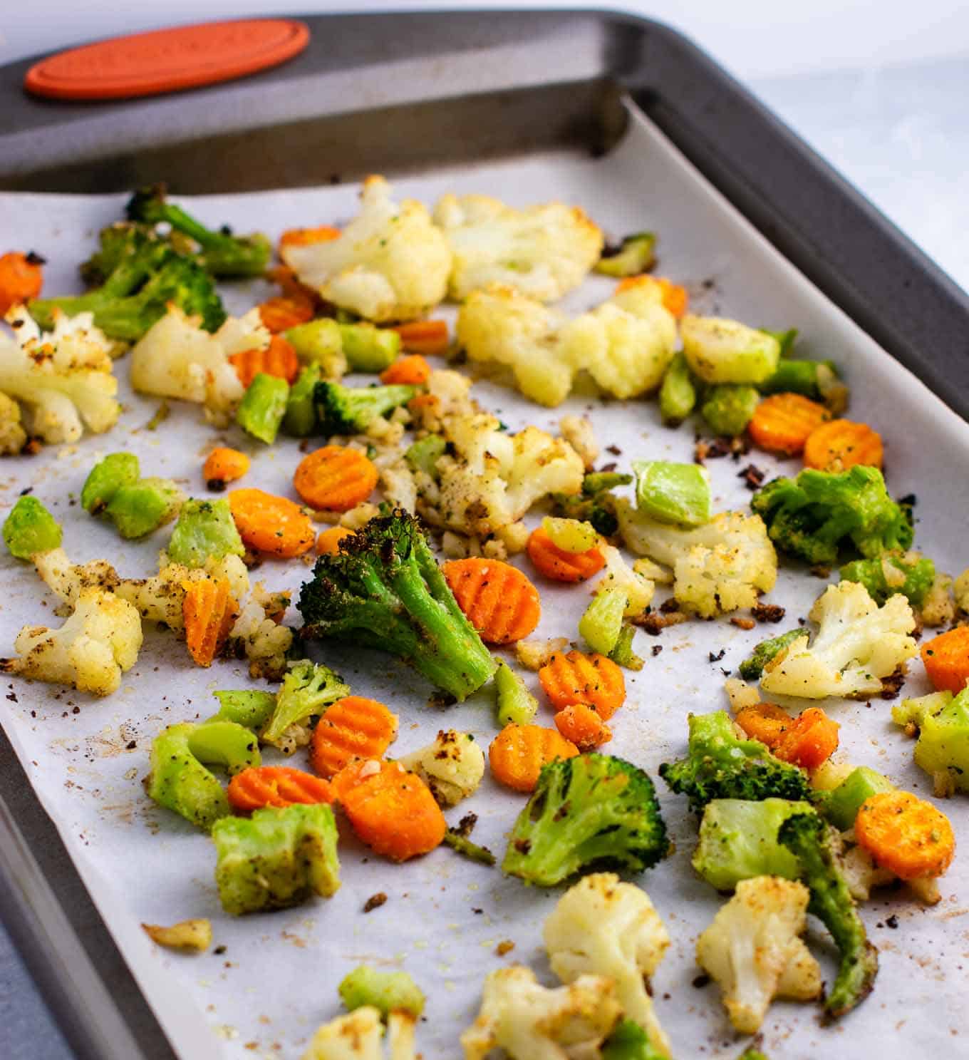 roasted vegetables on a parchment paper lined baking sheet