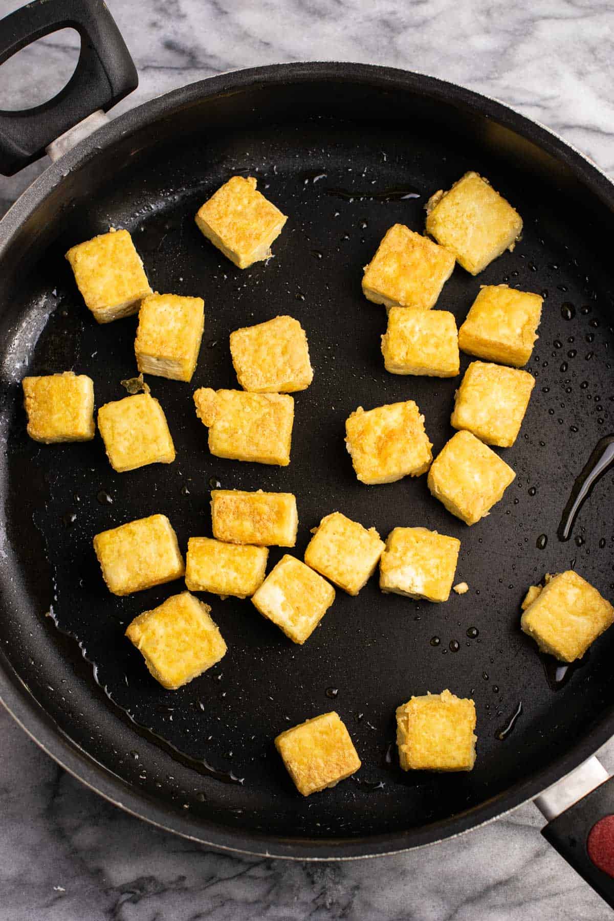 crispy tofu cubes in a skillet
