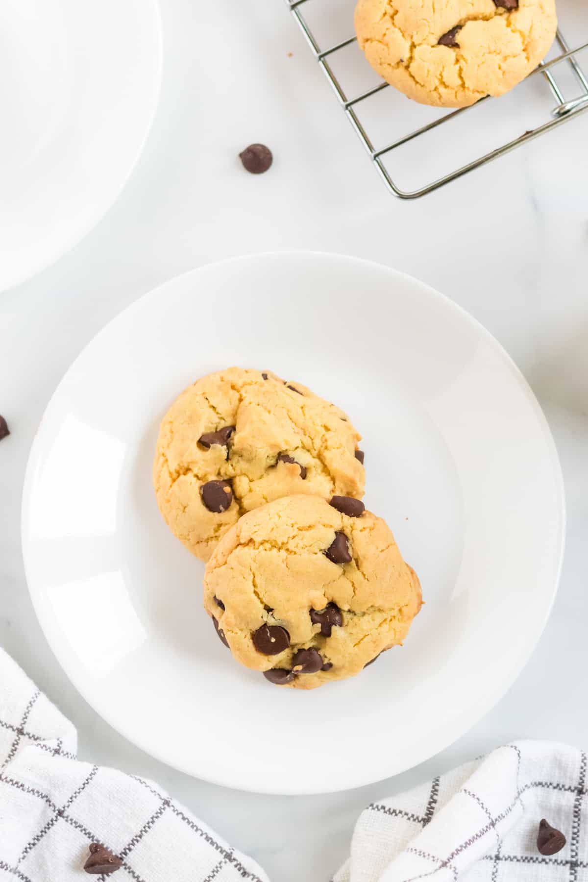 two yellow cake mix cookies on a white plate