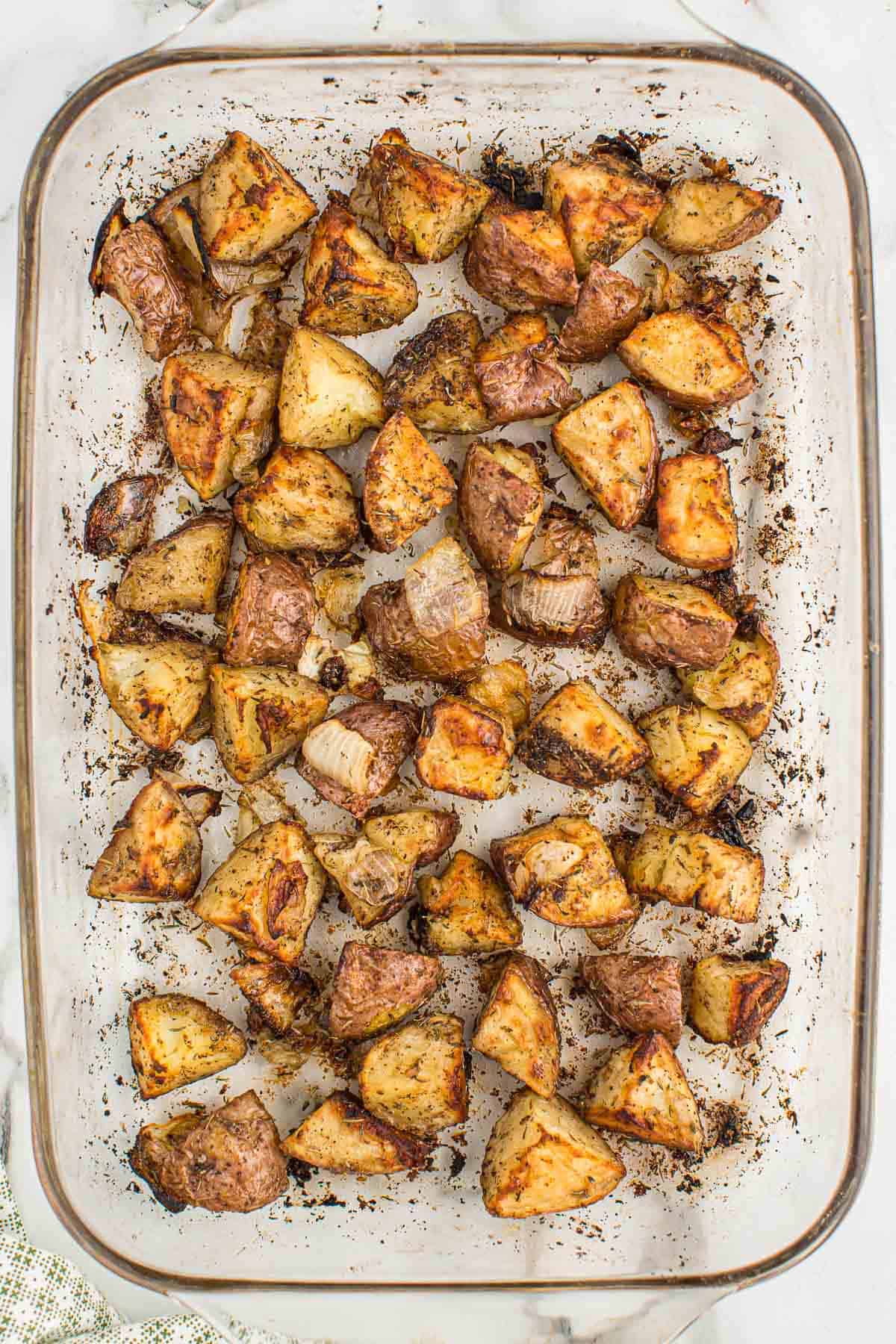 roasted potatoes and onions in a baking dish