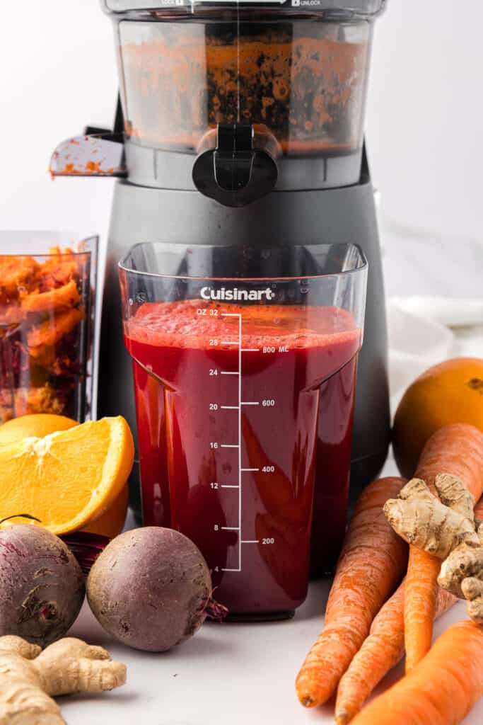 beet and carrot juice in the juicing canister