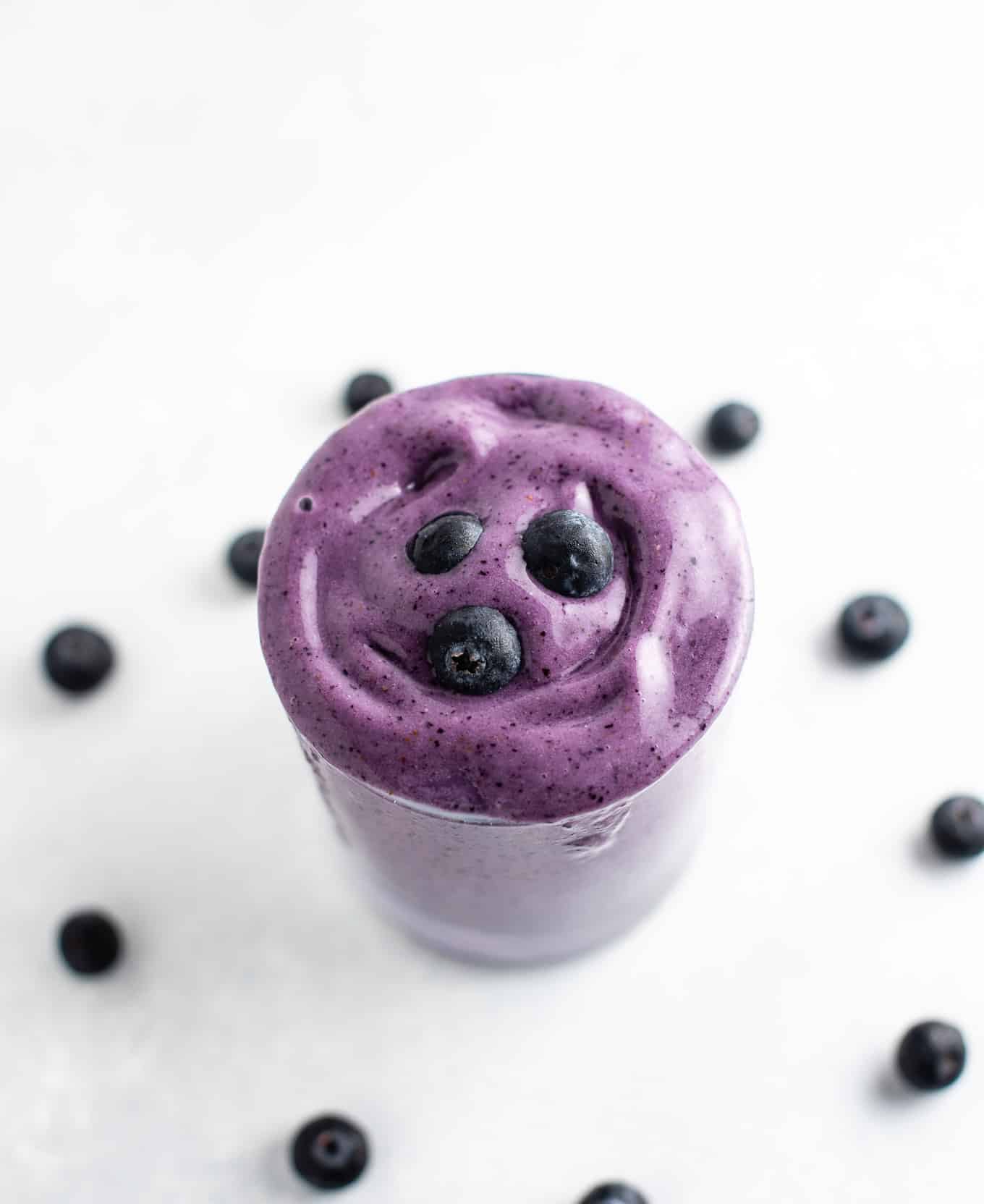  blueberry smoothie in a glass from an overhead view