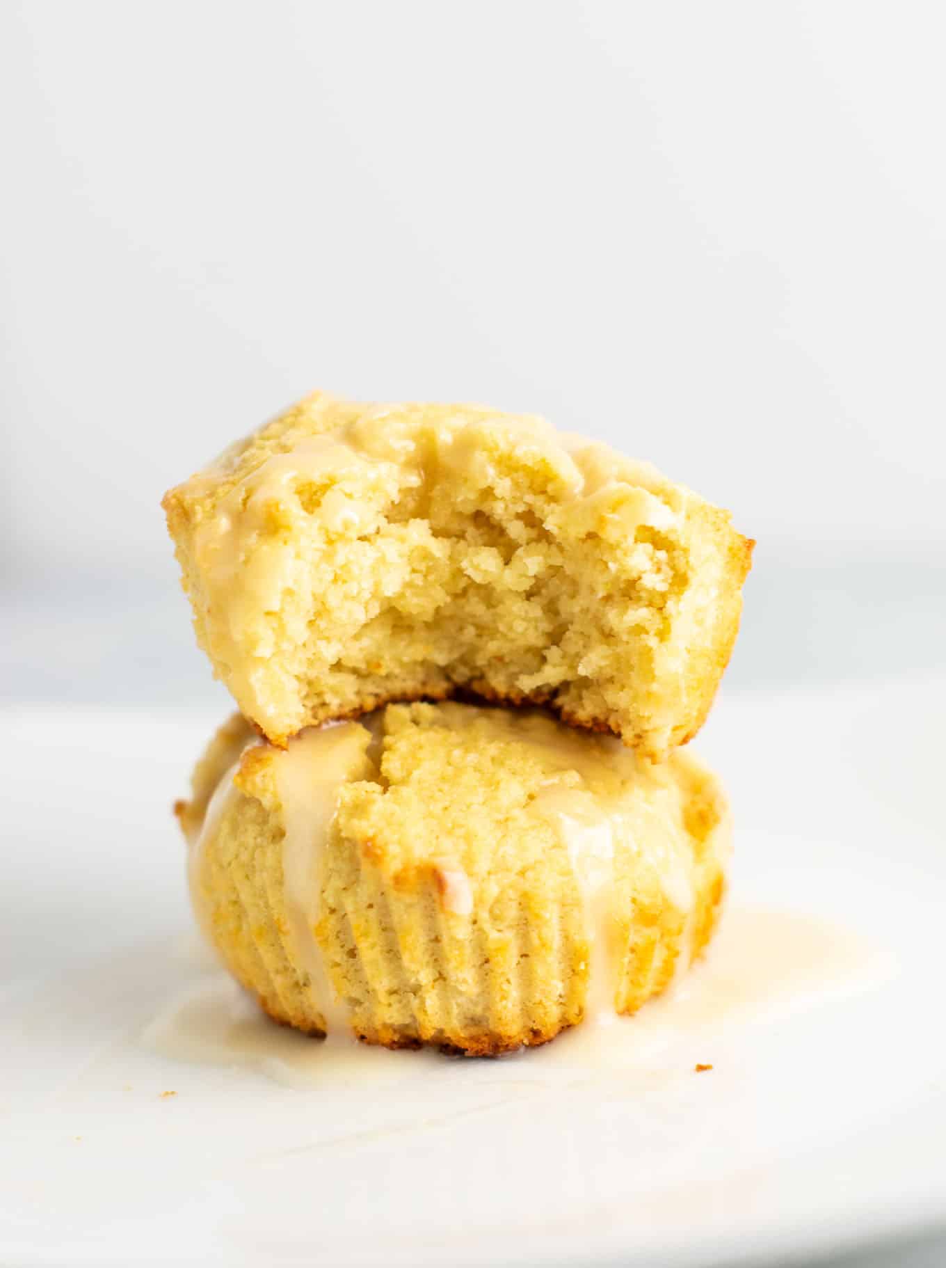 Gluten free lemon muffins with a sweet lemon glaze. These are perfectly fluffy, do not fall apart, and taste amazing! #glutenfree #lemonmuffins #breakfast