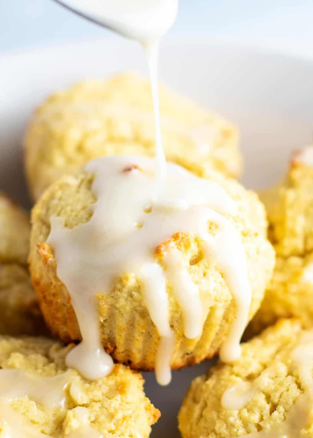 Gluten free lemon muffins with a sweet lemon glaze. These are perfectly fluffy, do not fall apart, and taste amazing! #glutenfree #lemonmuffins #breakfast