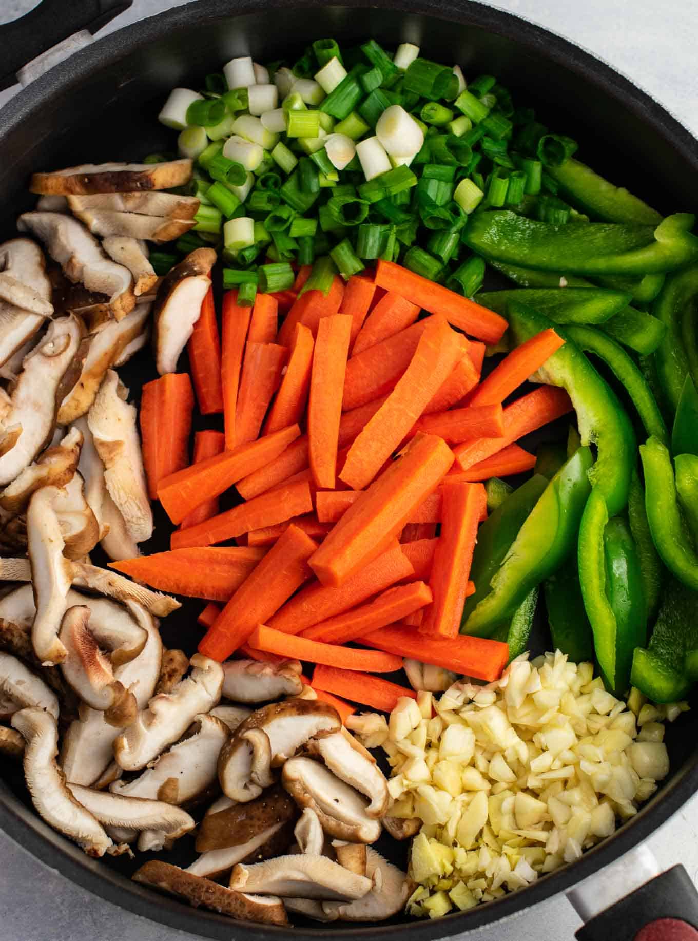 Ramen noodle stir fry with golden oak shitake mushrooms, sugar snap peas, green bell pepper, carrots, green onions, and fresh garlic and ginger. 